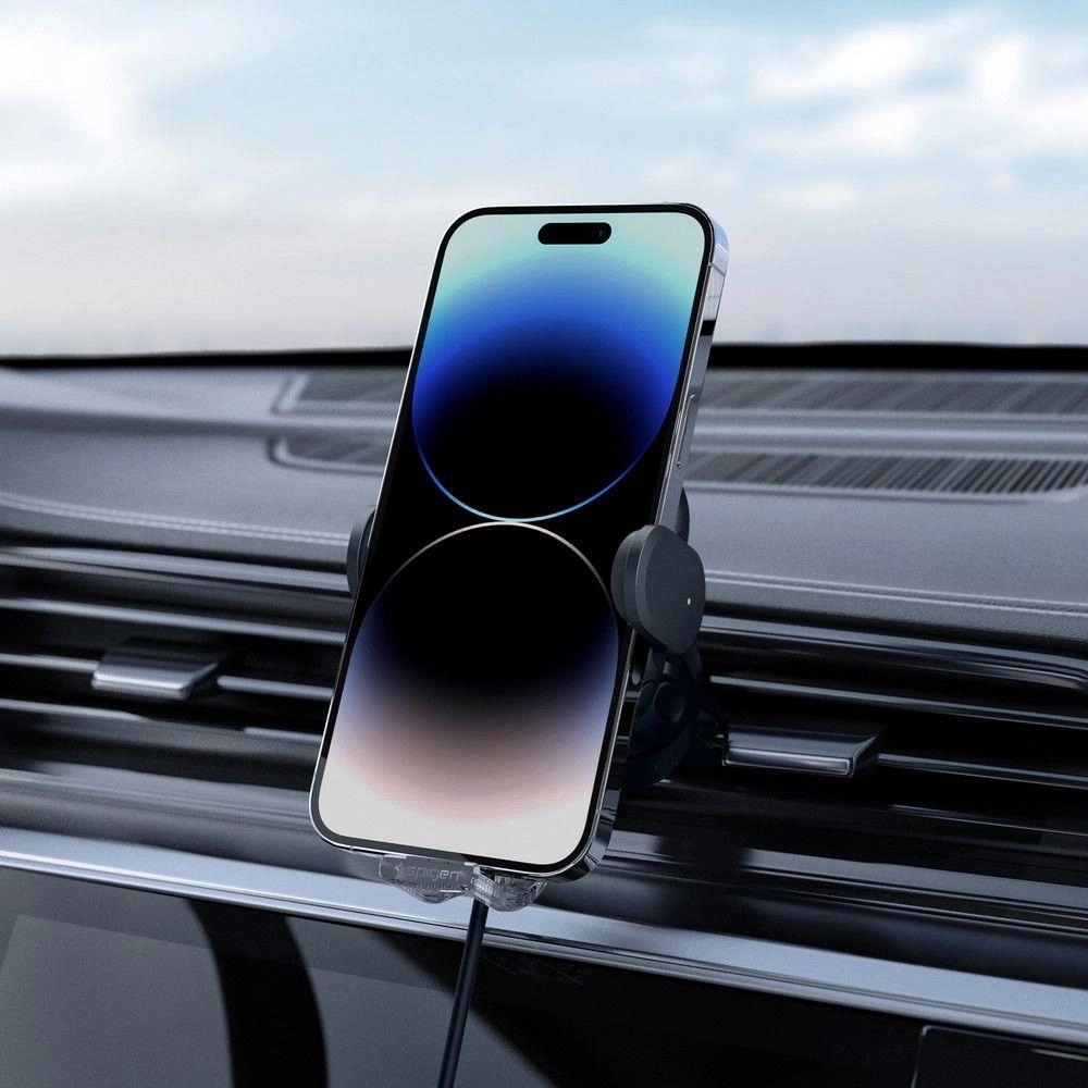 Phone in a car mount on a vent, with a charging cable attached.