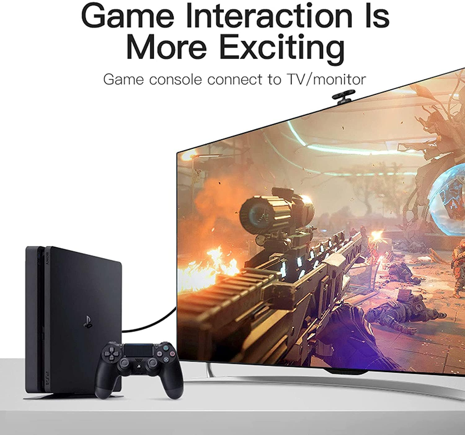 Black game console with controller in front of a large screen displaying an action game.