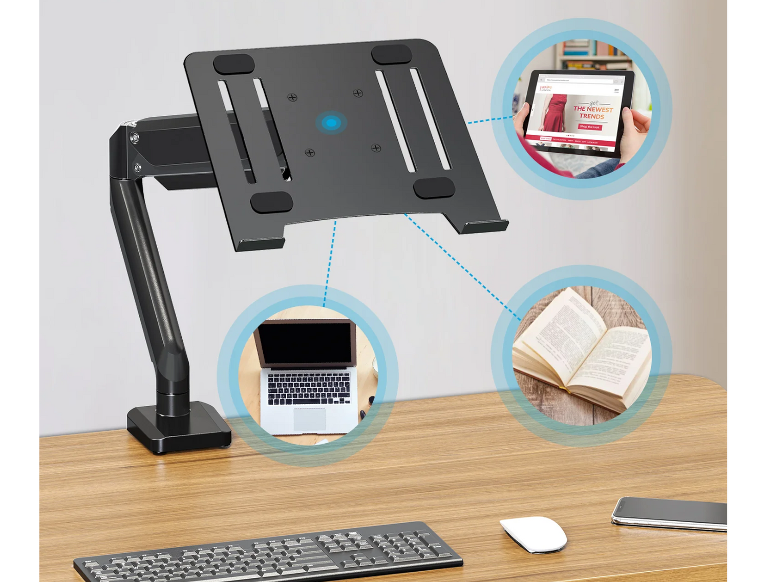 Biurko ze stojakiem na laptopa, laptopem, tabletem, książką i klawiaturą.