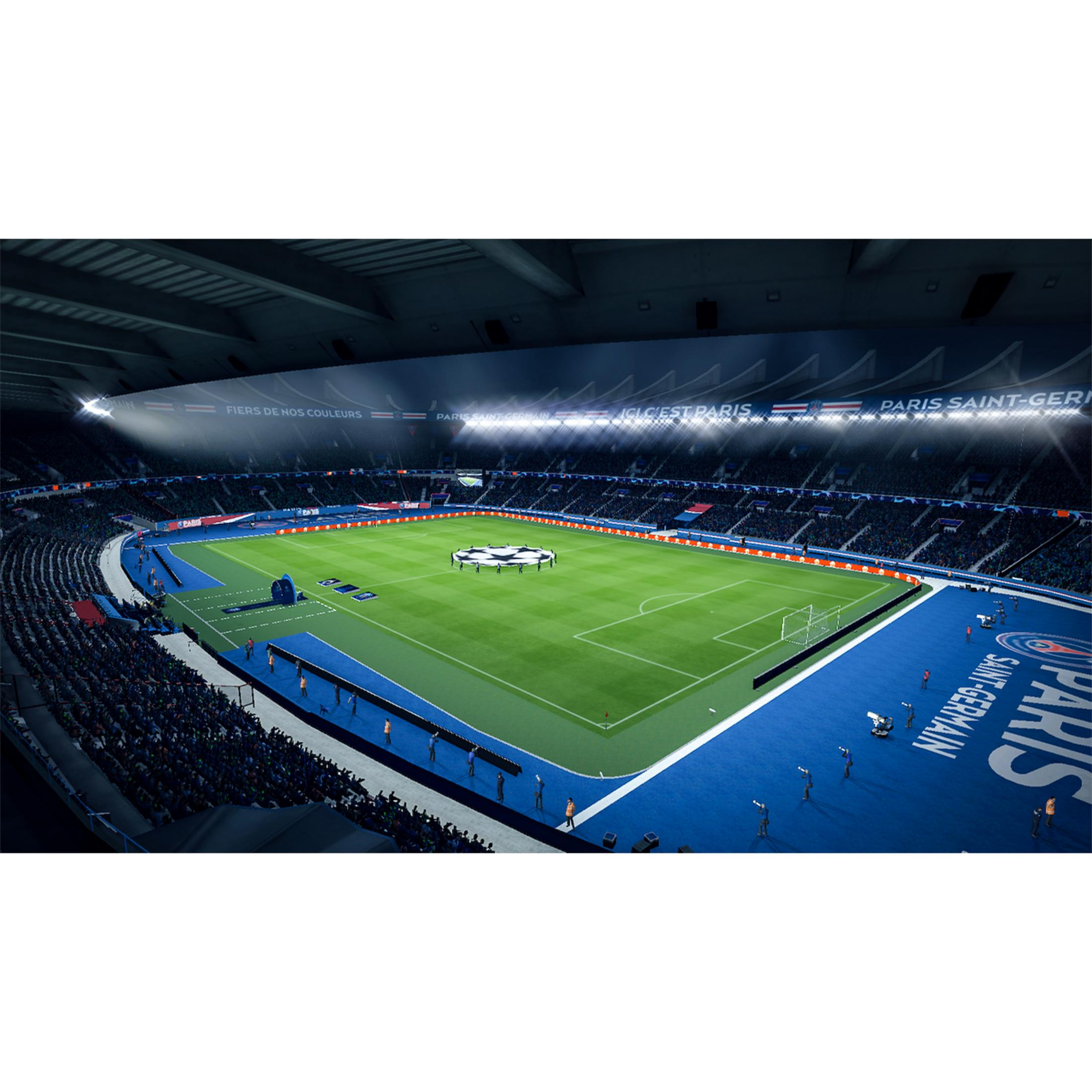 Un estadio de fútbol por la noche, iluminado por focos brillantes, con espectadores.