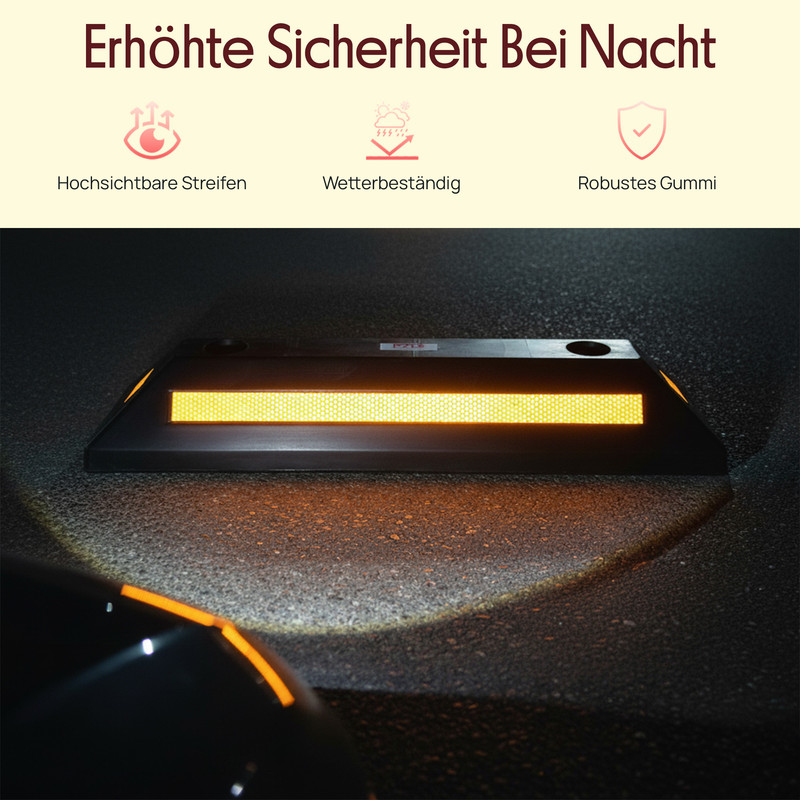 Ein schwarzer Parkstopper mit gelben Reflektoren auf Asphalt bei Nacht.