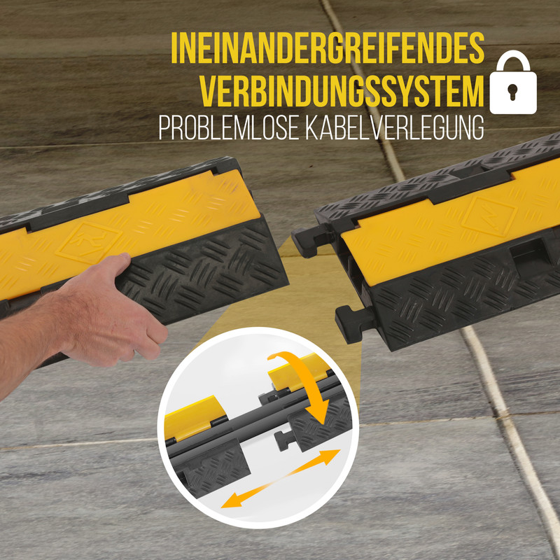 Mann verbindet gelbe und schwarze Kabelbrücken auf grauem Boden.