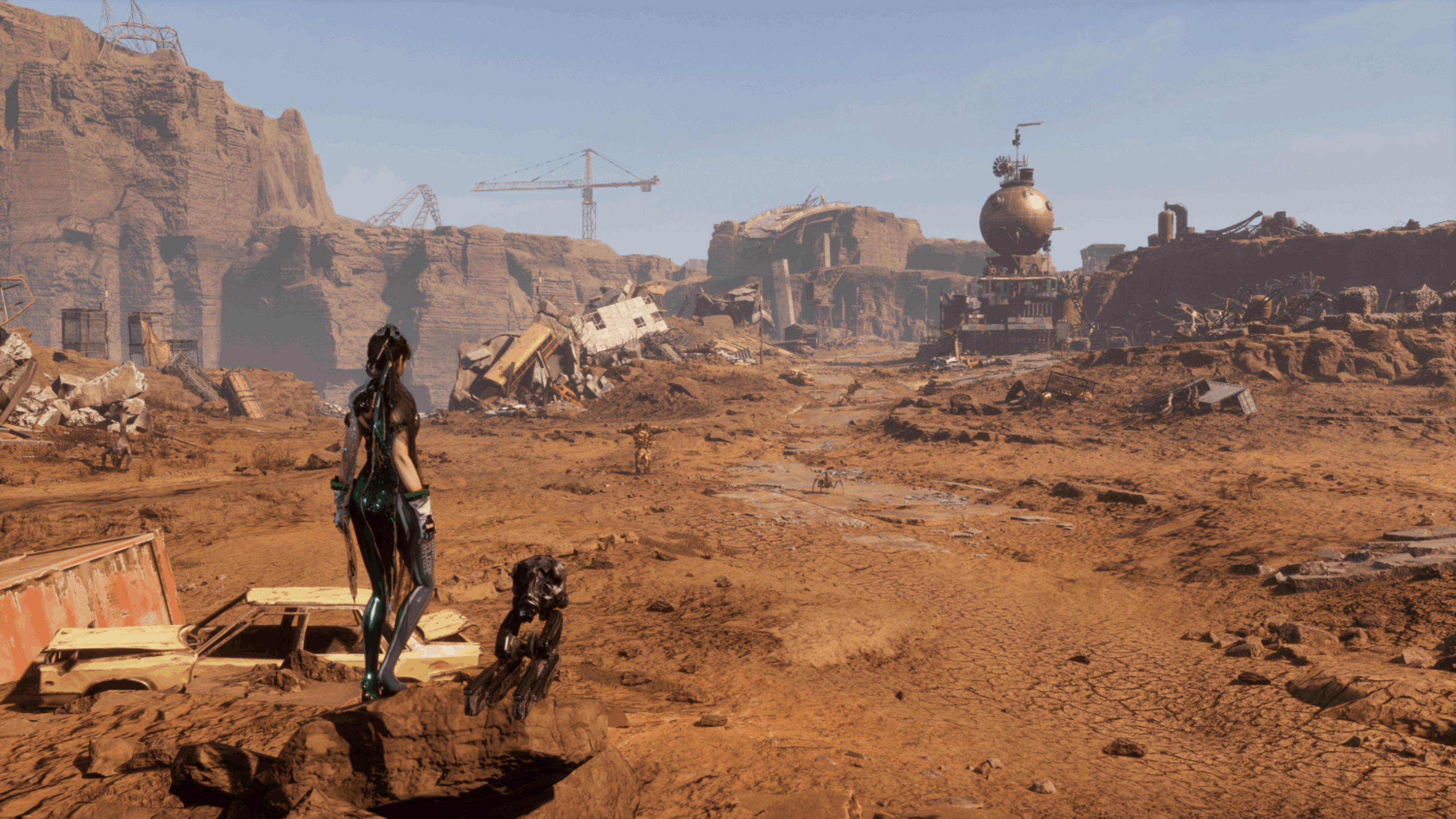 Una mujer con traje futurista se alza sobre roca, mirando un paisaje árido y desolado con ruinas.