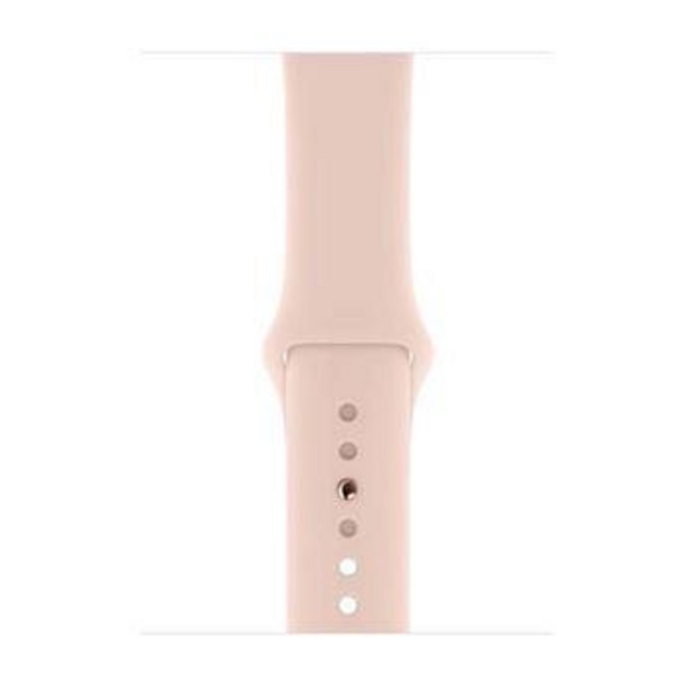 Un cinturino per orologio rosa pallido con fori per la regolazione.