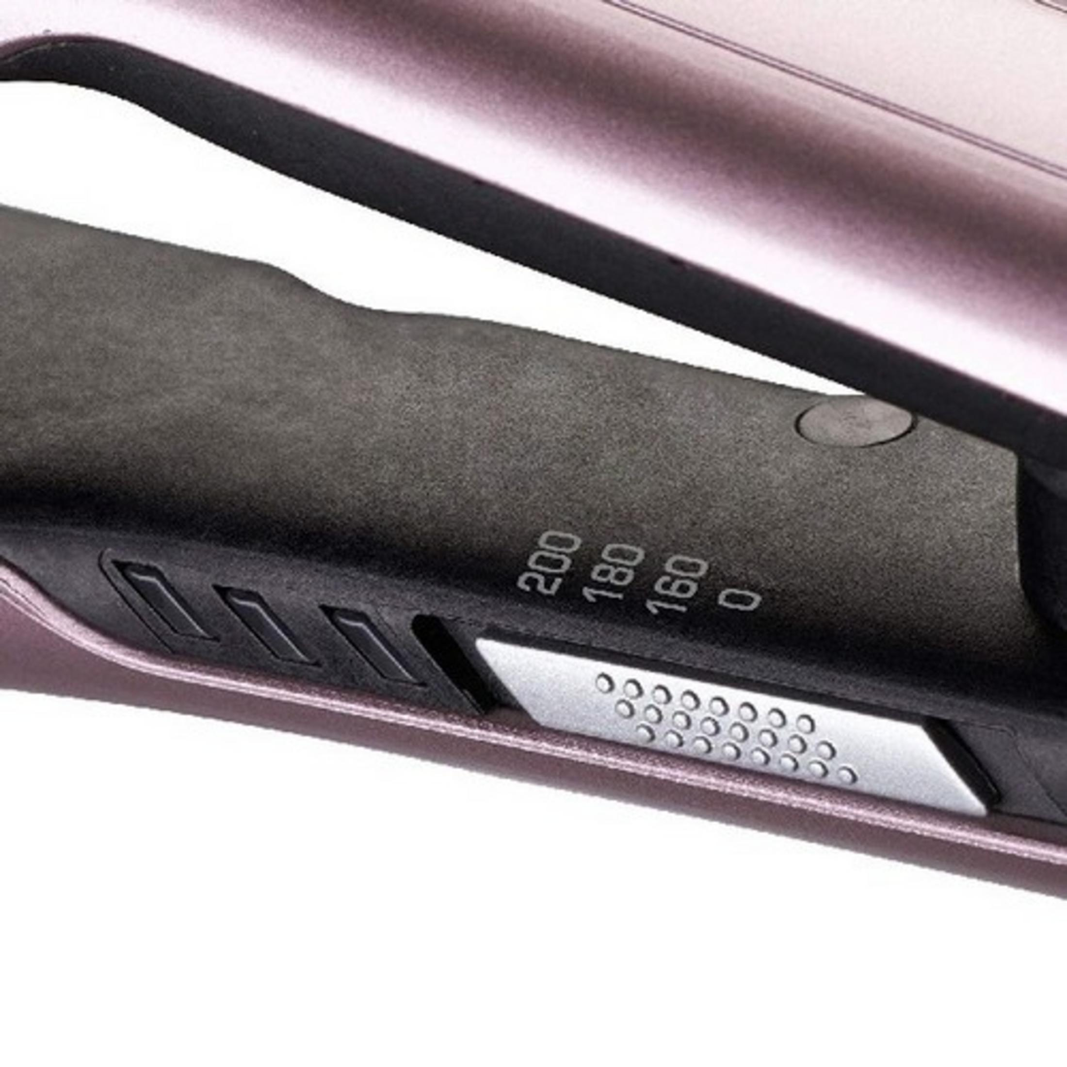 Primo piano di una piastra per capelli oro rosa con impostazioni di temperatura.