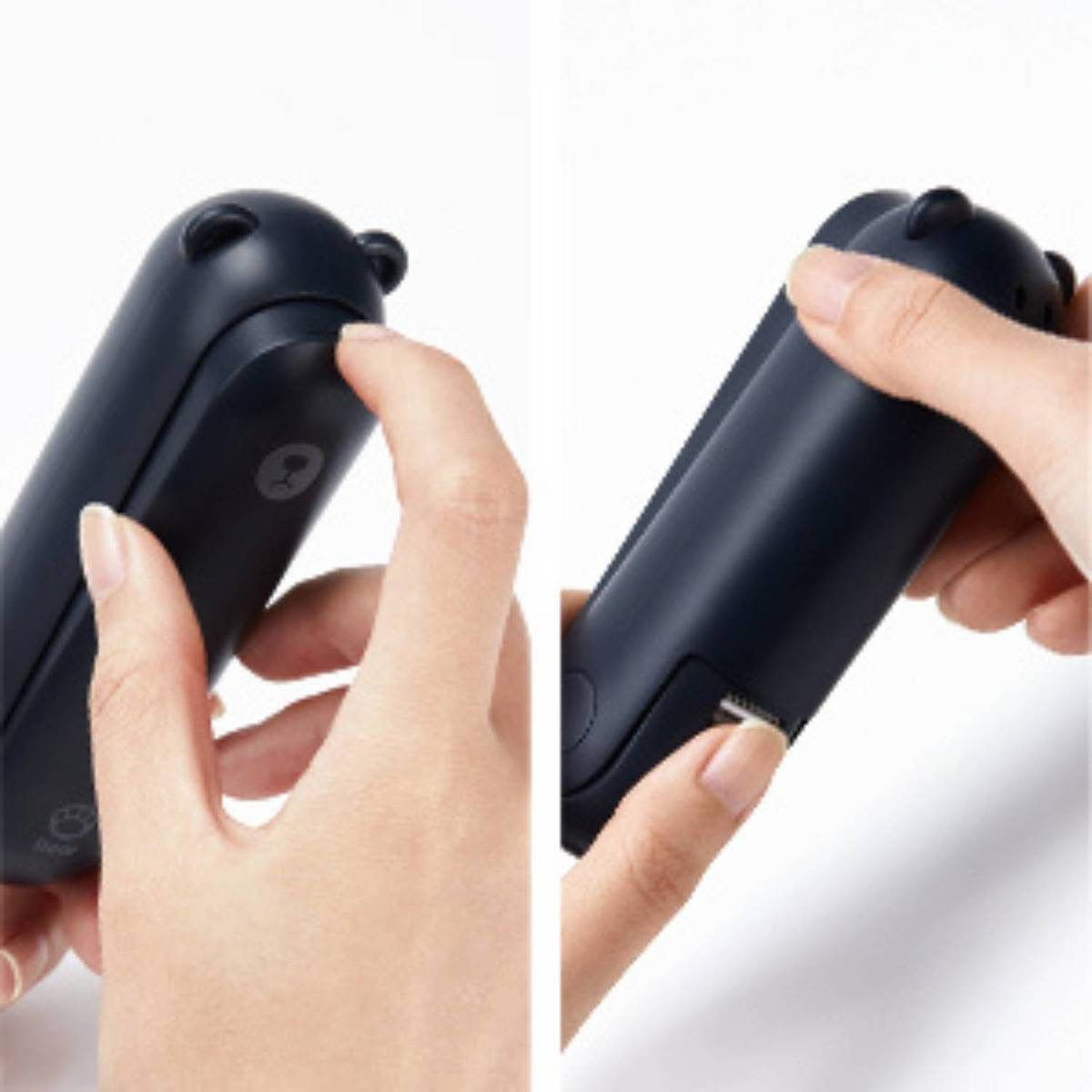 Eine Hand drückt einen Knopf an einem dunkelblauen Gerät mit Bärenohren.