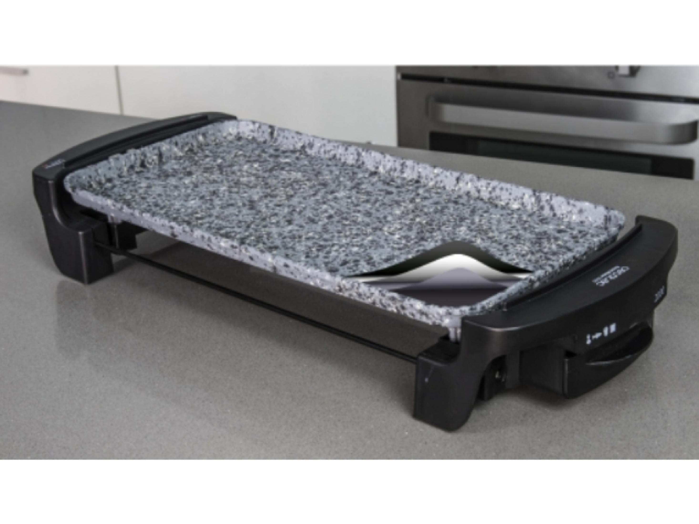 A gray electric grill with a black base on a countertop.