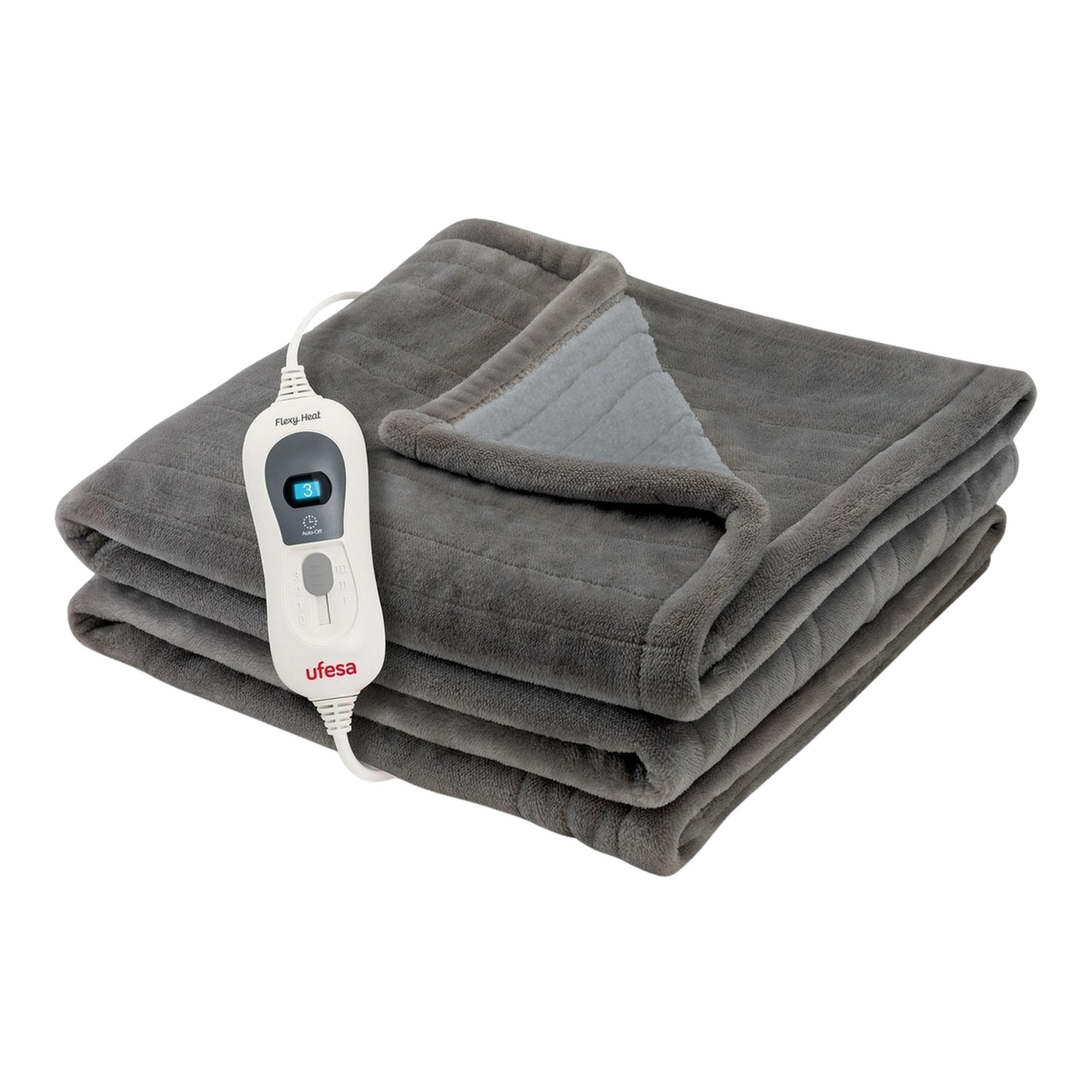 Coperta termica grigia piegata con il suo controller.