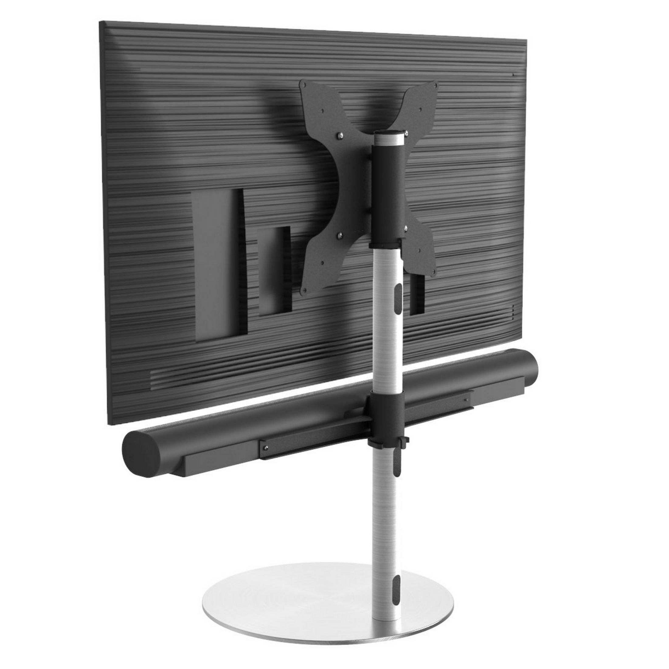Parte trasera de un televisor en un soporte giratorio con barra de sonido.