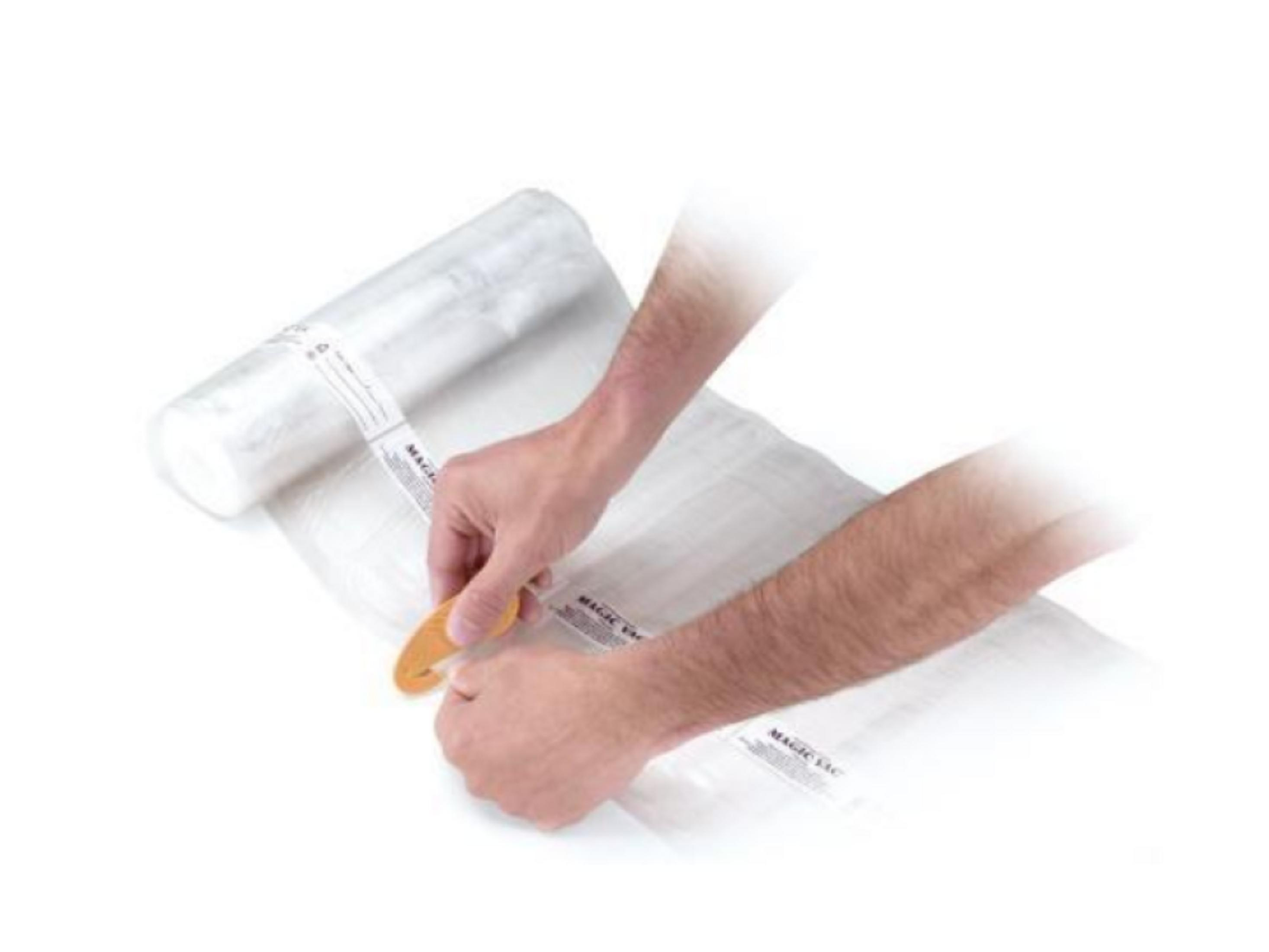 Mani tagliano un sacchetto di plastica con uno strumento giallo.