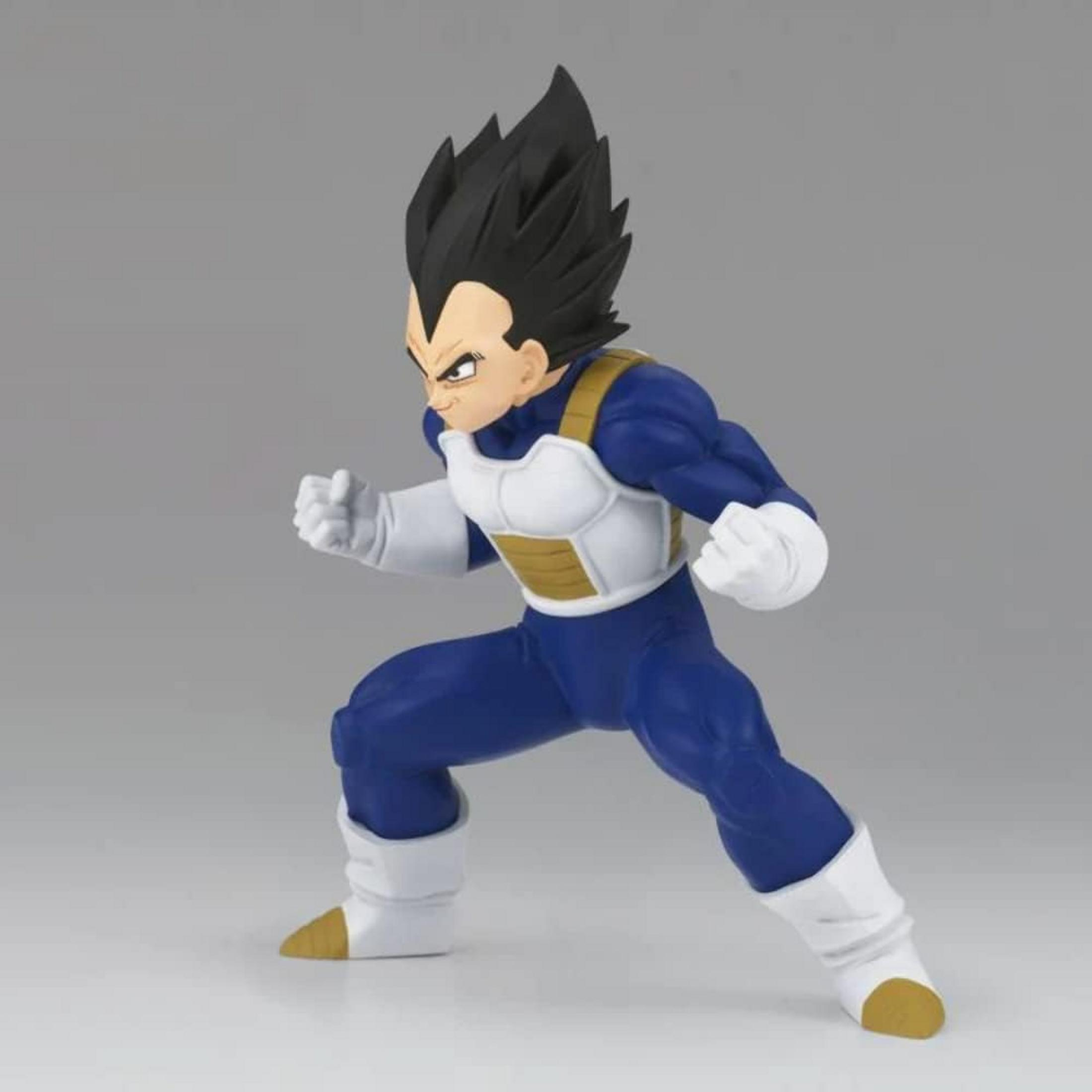 Una figura de Vegeta con uniforme azul y armadura blanca está en pose de lucha.