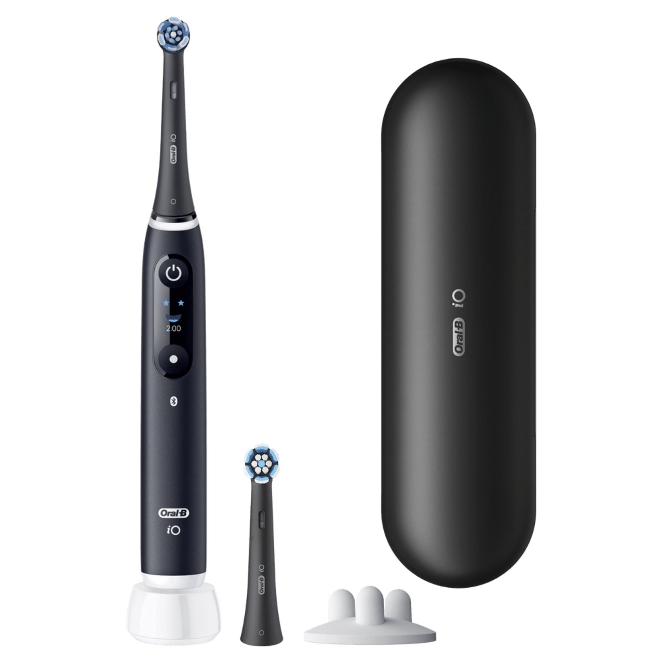 Black electric toothbrush with charging case, brush head, and holder.