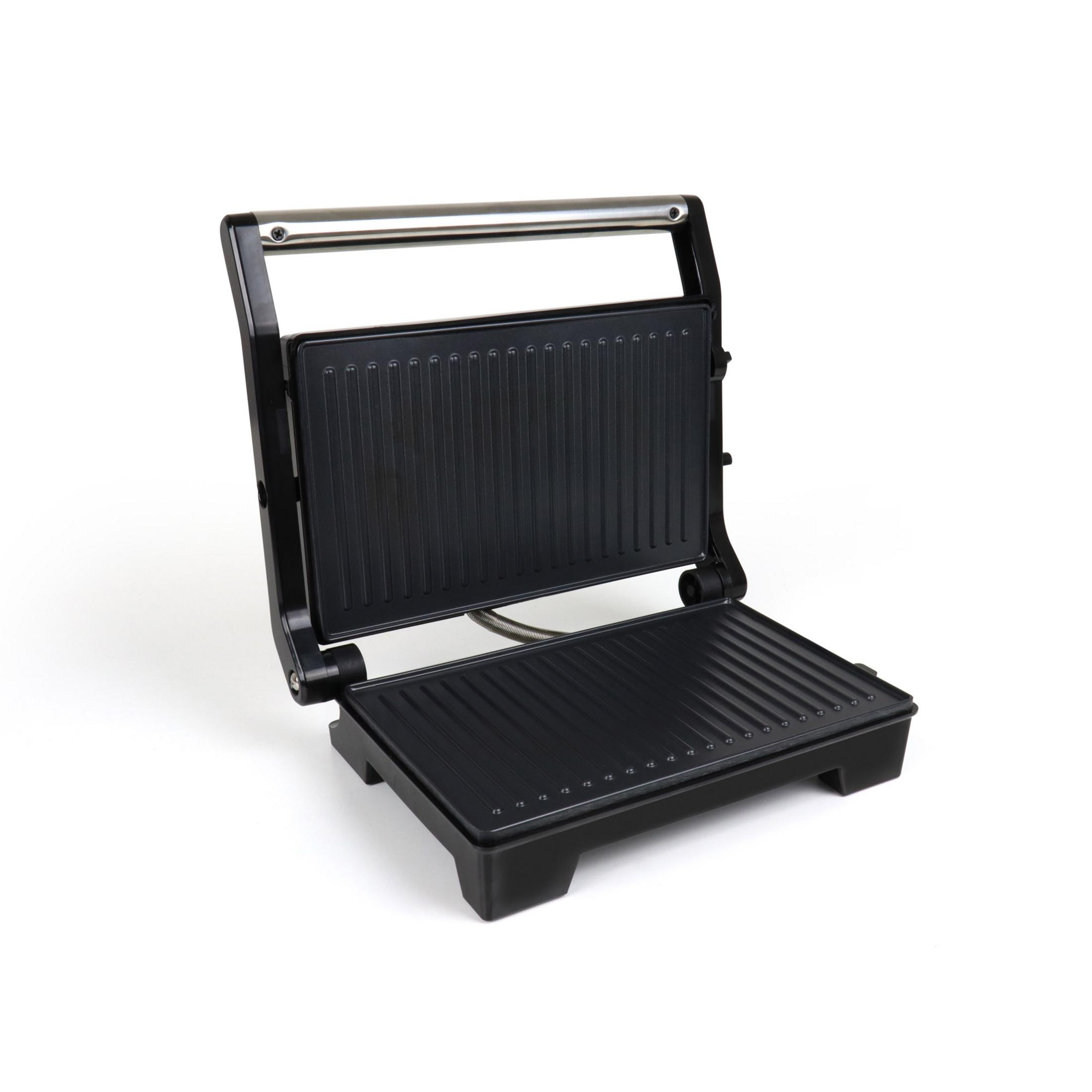 Ein offener schwarzer Kontaktgrill mit geriffelten Platten und einem Metallgriff.