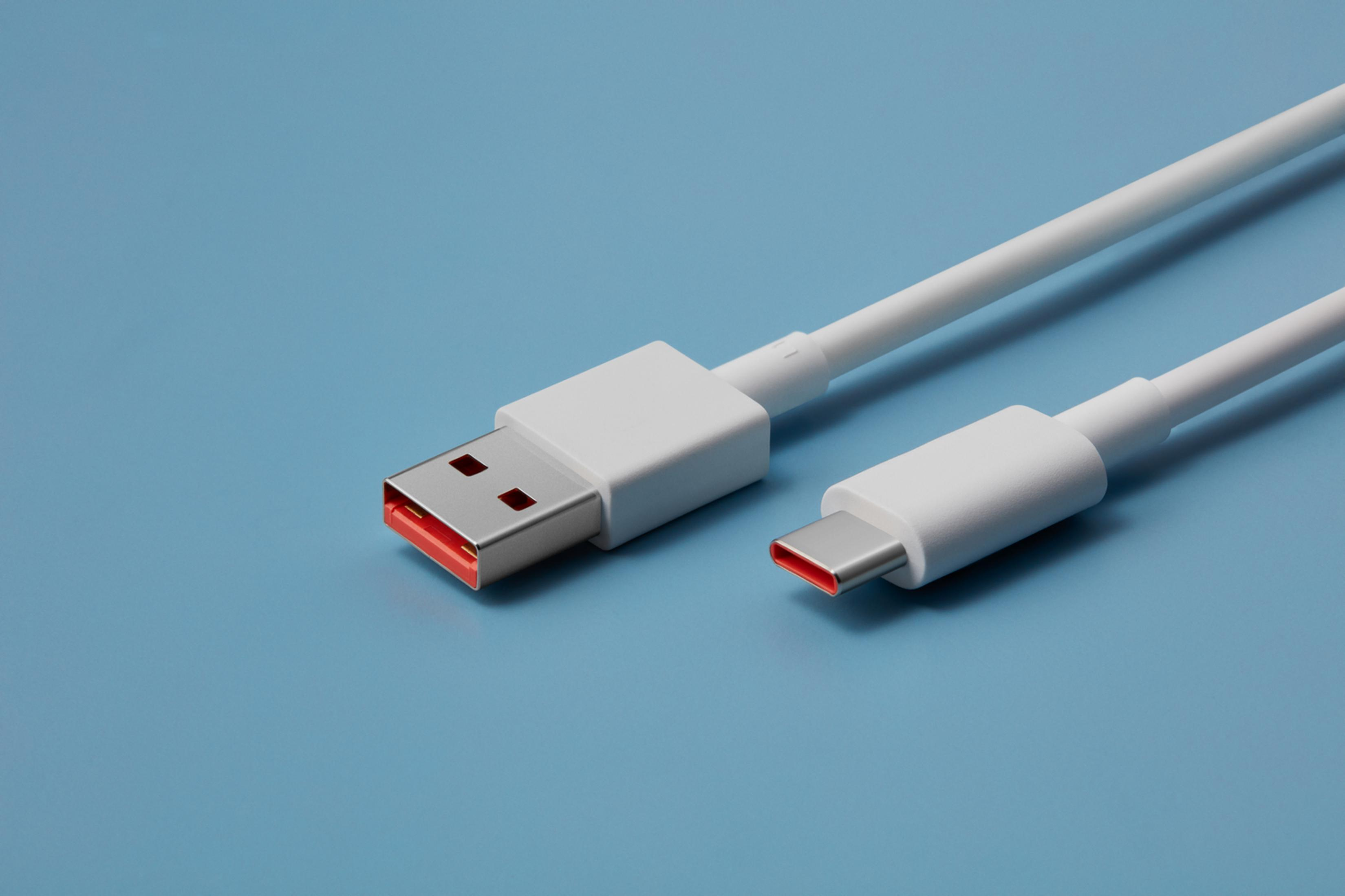 A white USB-C cable with red accents on a blue background.