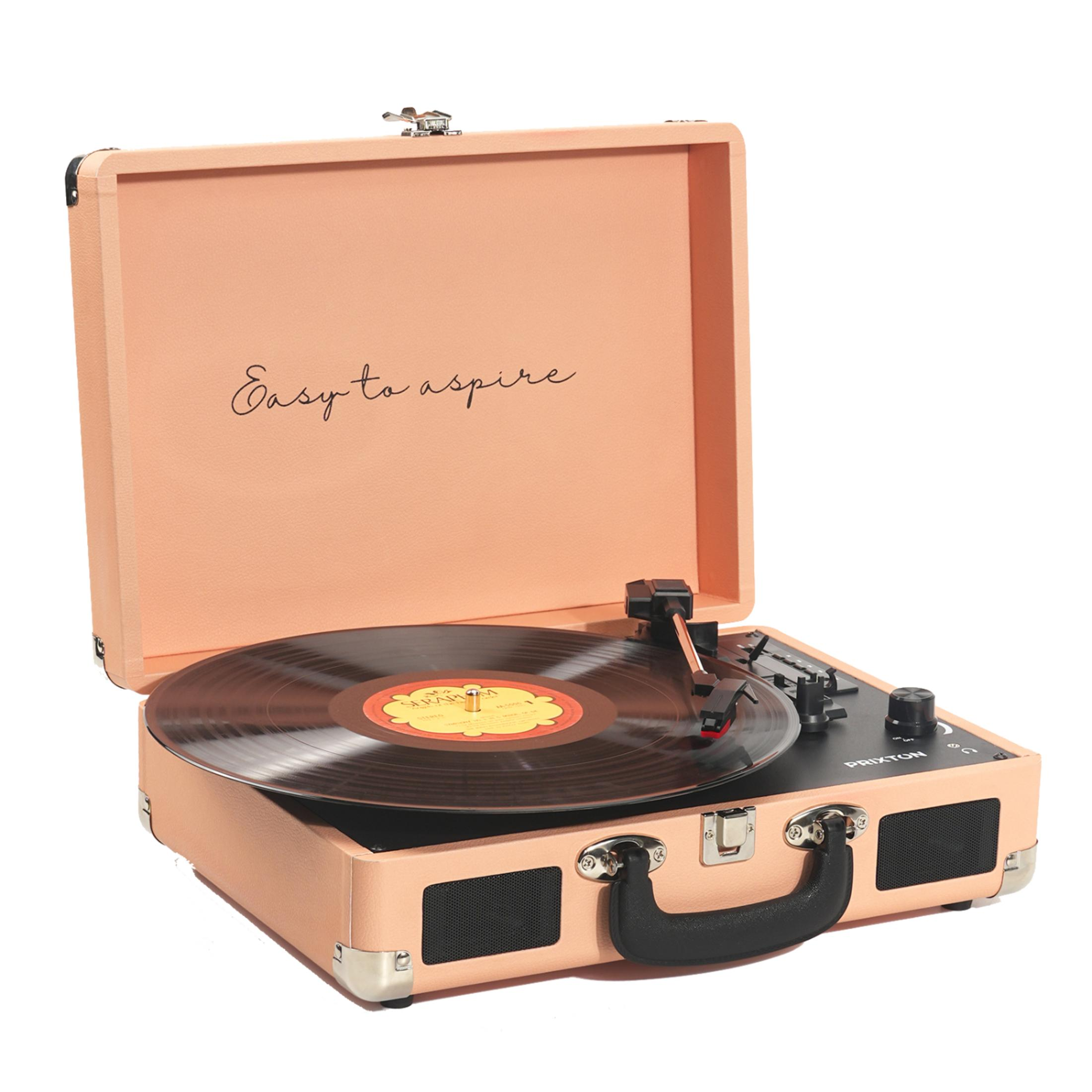 An open, peach-colored record player with a vinyl record and needle.