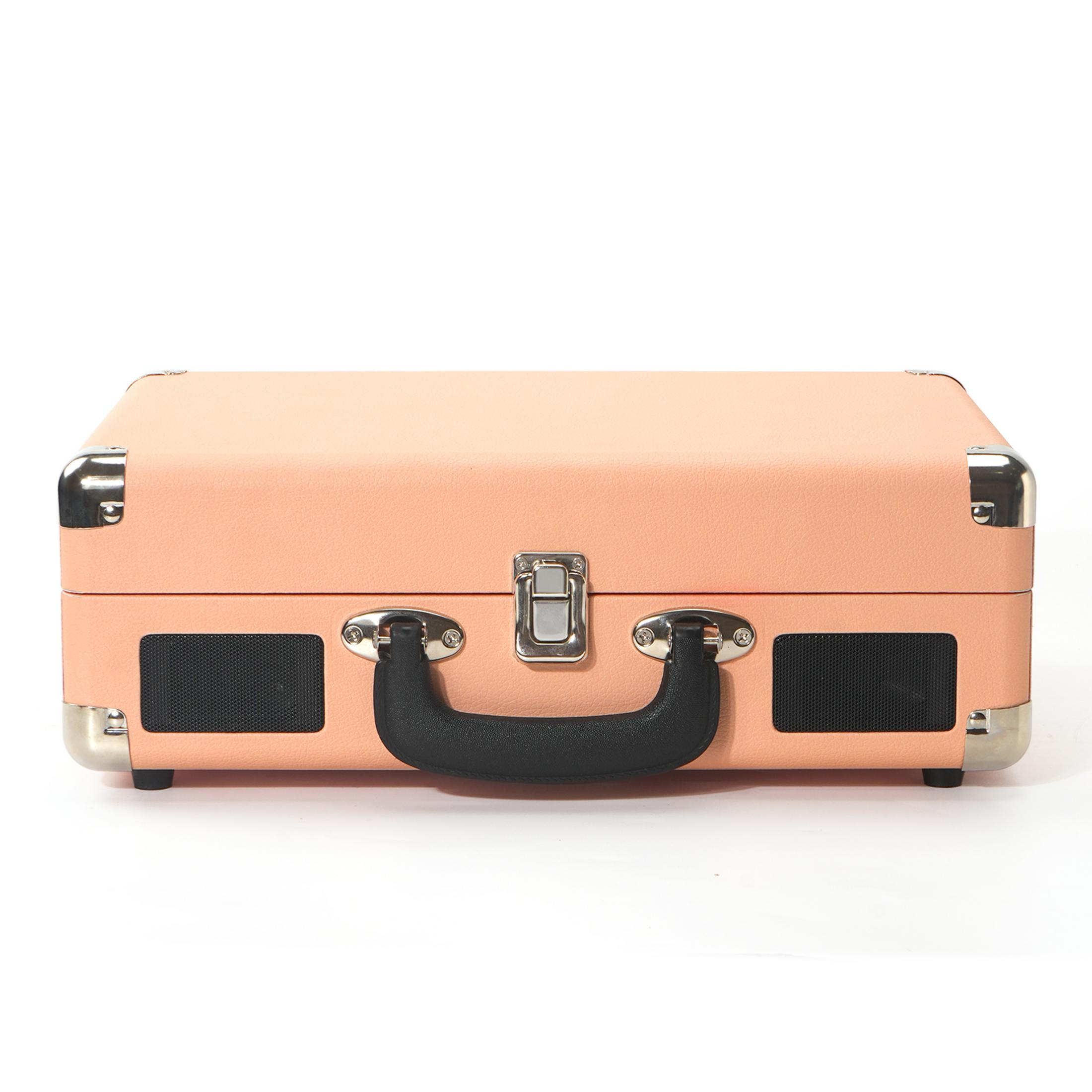 A peach-colored record player with black speaker grilles and a silver latch.