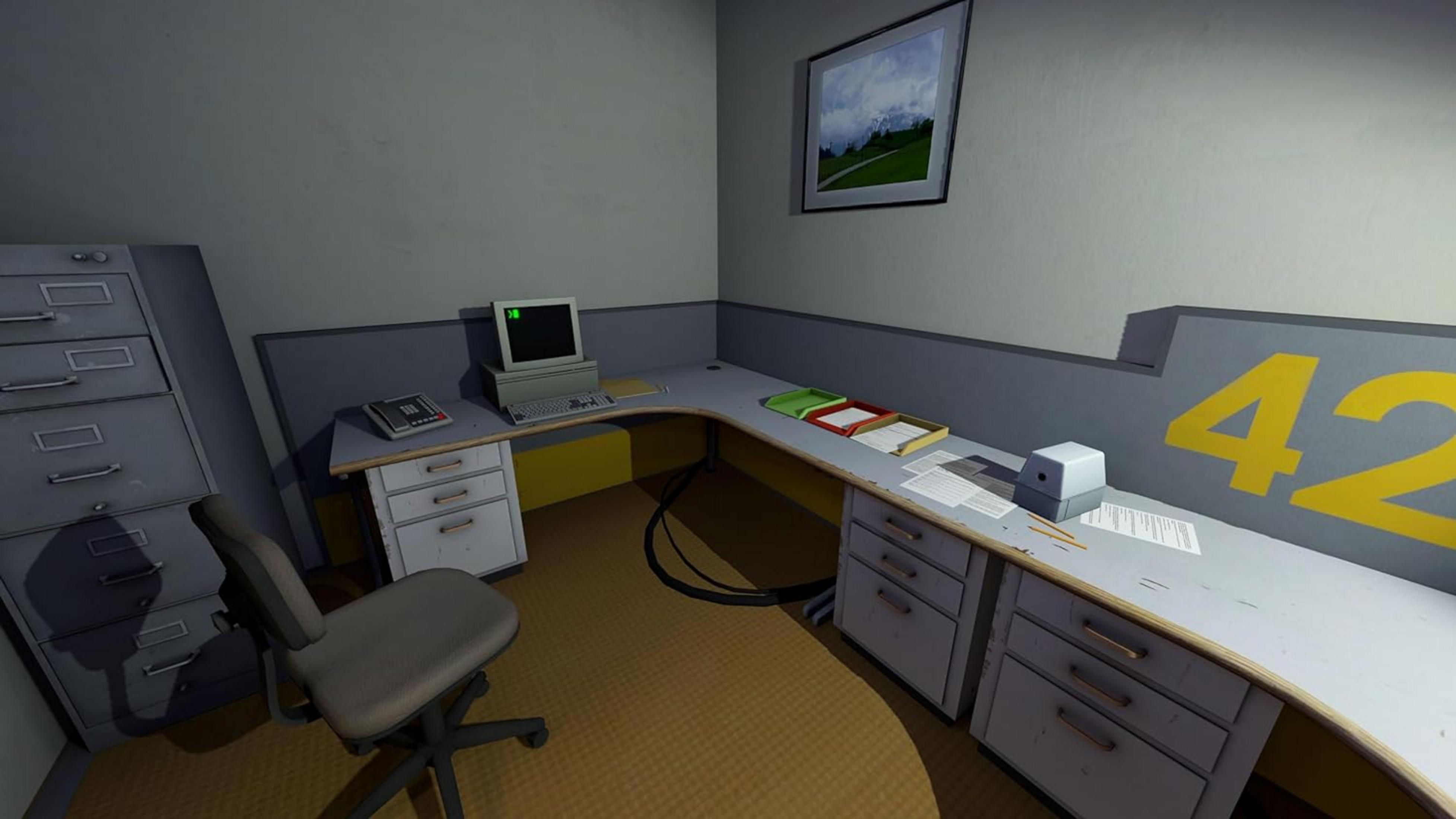 Ufficio con scrivania, computer, schedario e un quadro alla parete.