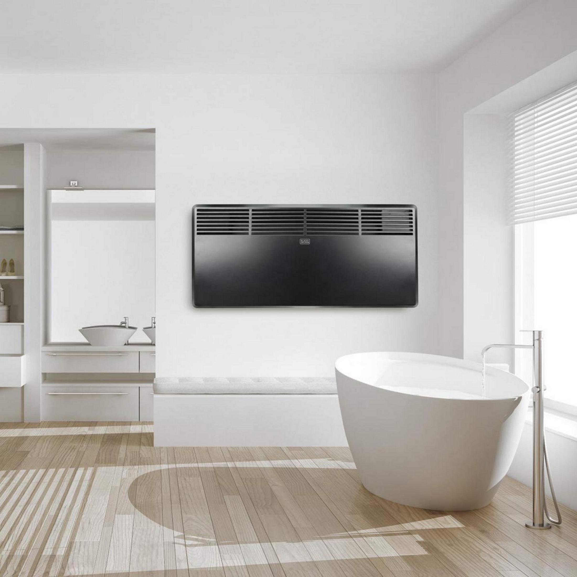 Un baño moderno con bañera exenta, lavabo y calefactor de pared.