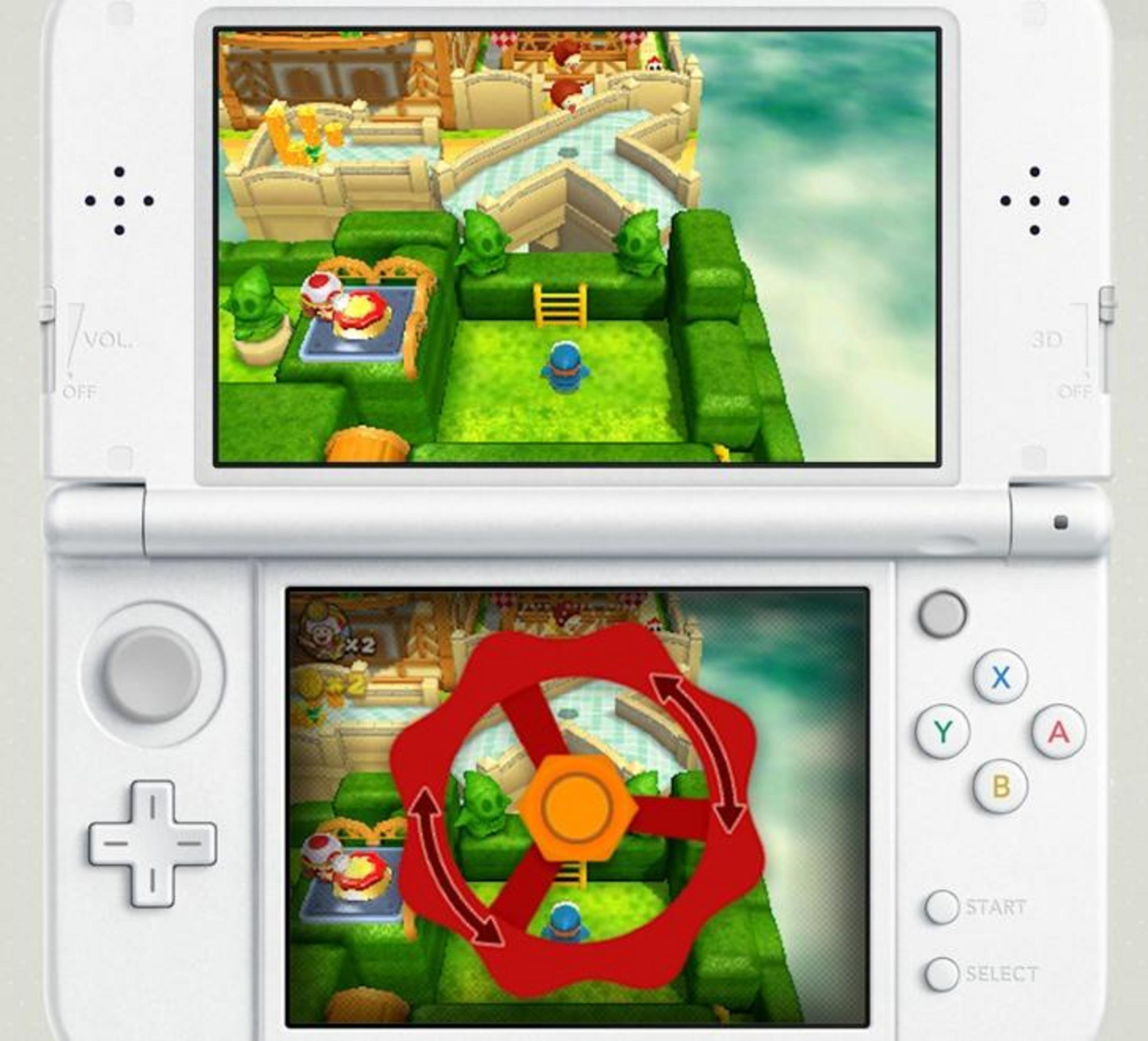 Due schermi mostrano un videogioco colorato. Schermo superiore: personaggio blu su sentiero verde. Schermo inferiore: volante rosso.