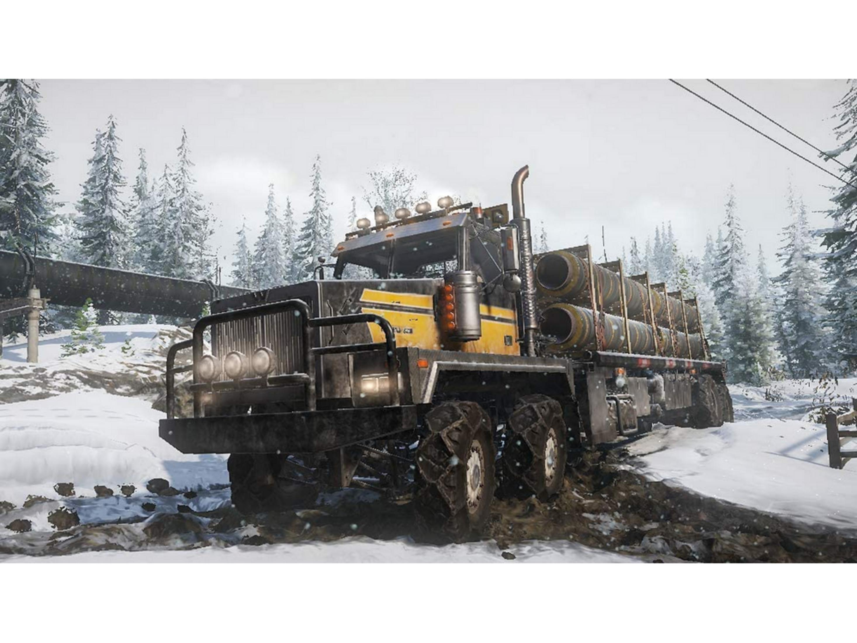 Un camion giallo e nero con tubi guida attraverso neve e fango.