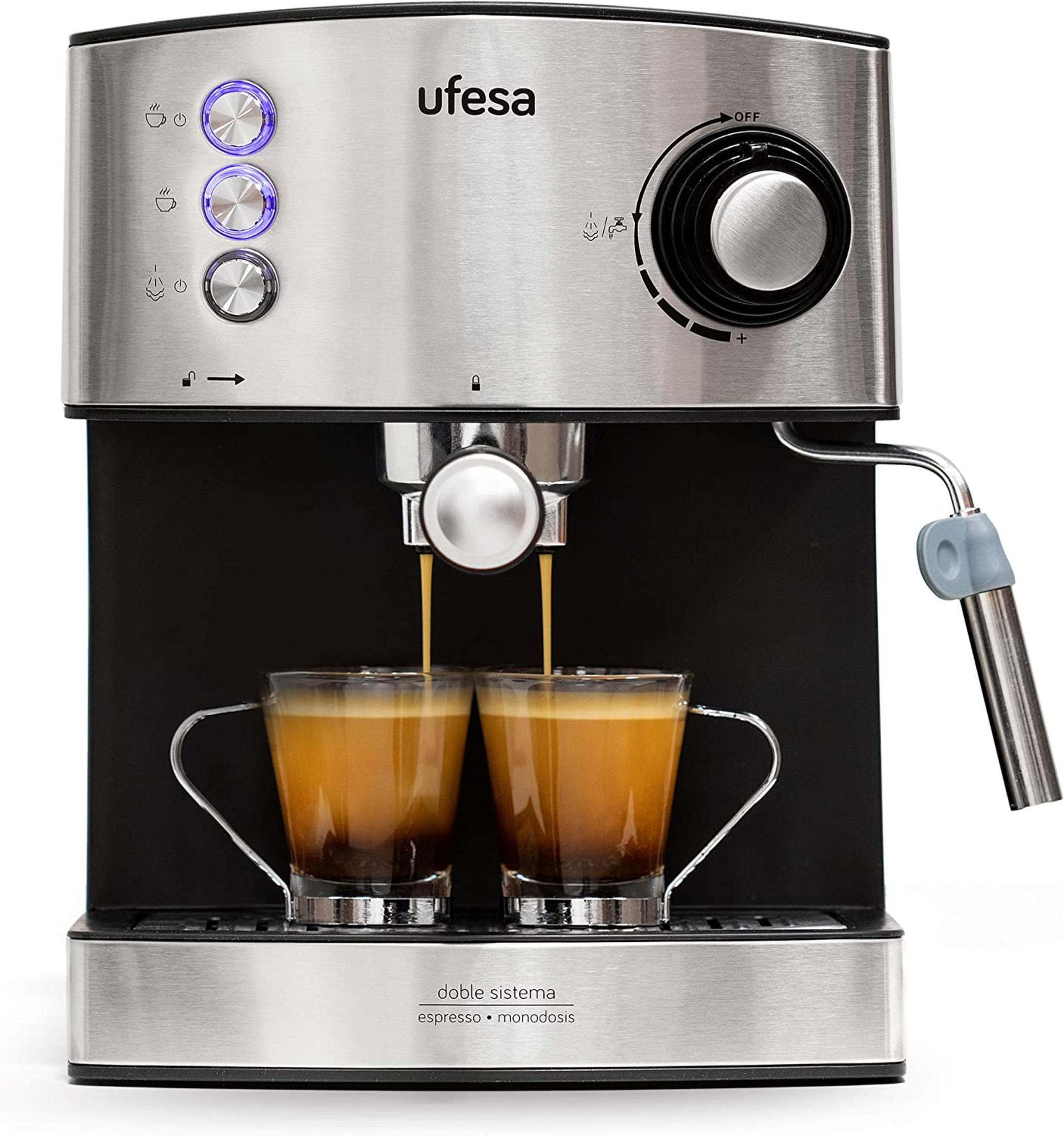 Una cafetera espresso plateada prepara dos tazas de espresso.