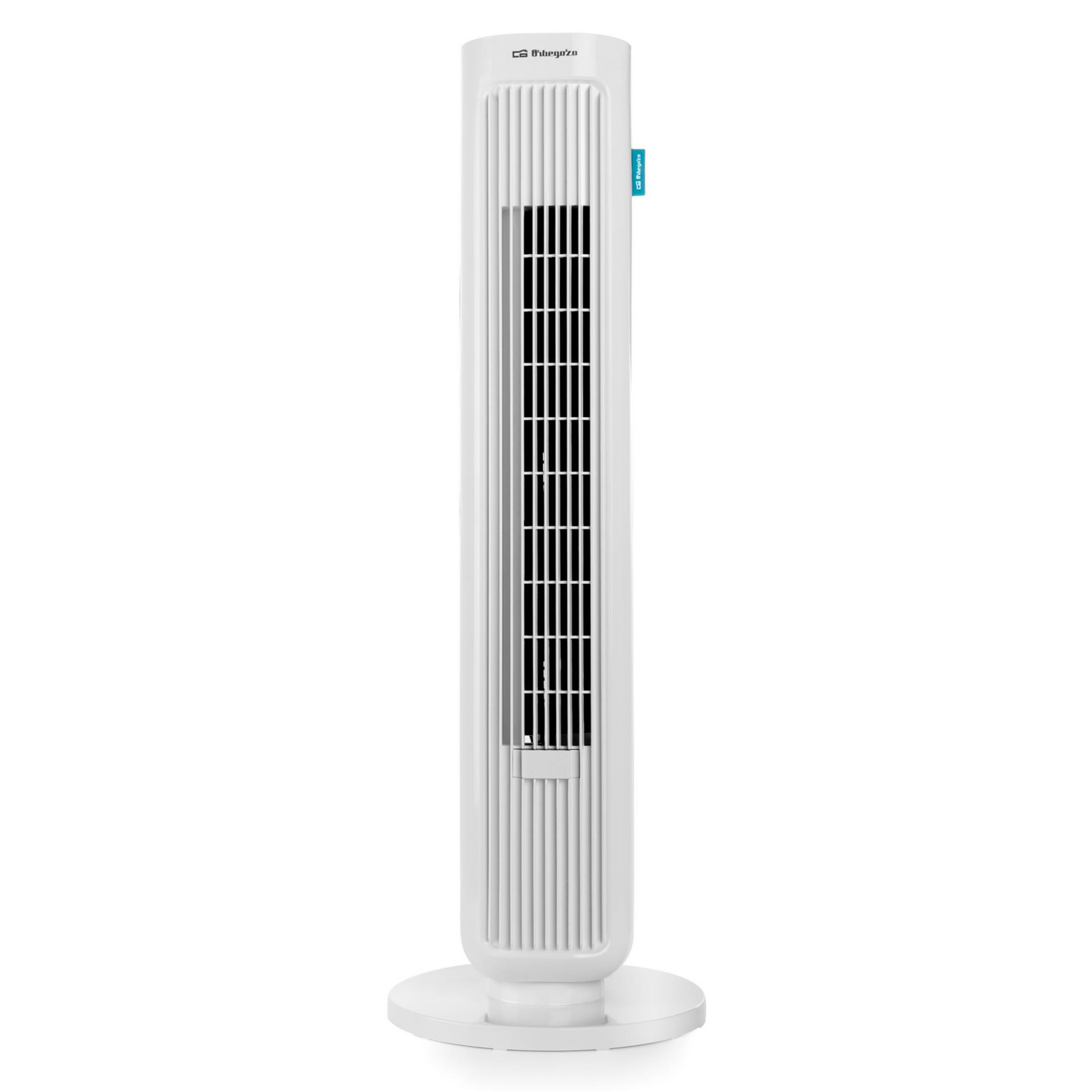 A white tower fan stands on a round base.
