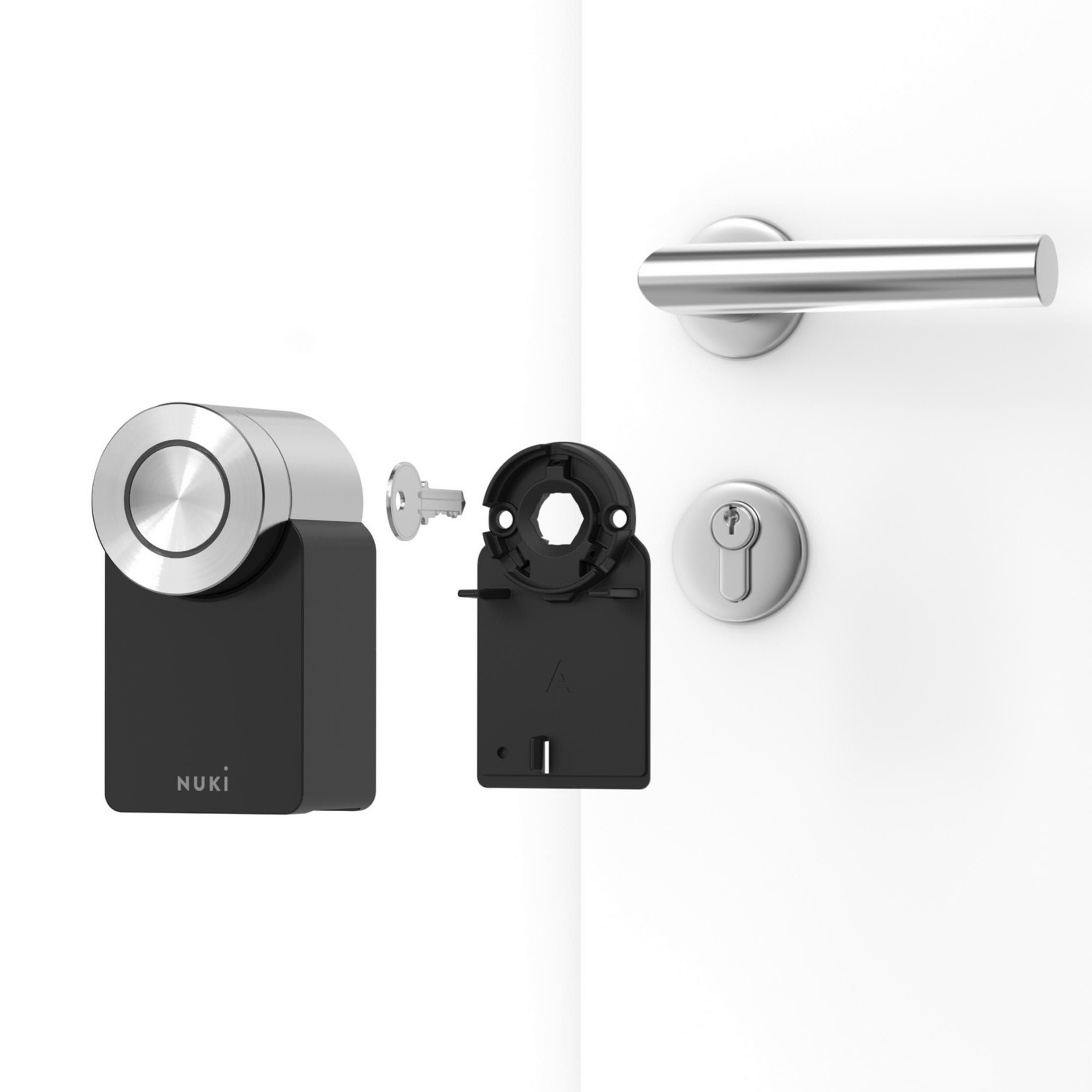Partes de cerradura inteligente Nuki: cerradura, llave y placa de montaje.