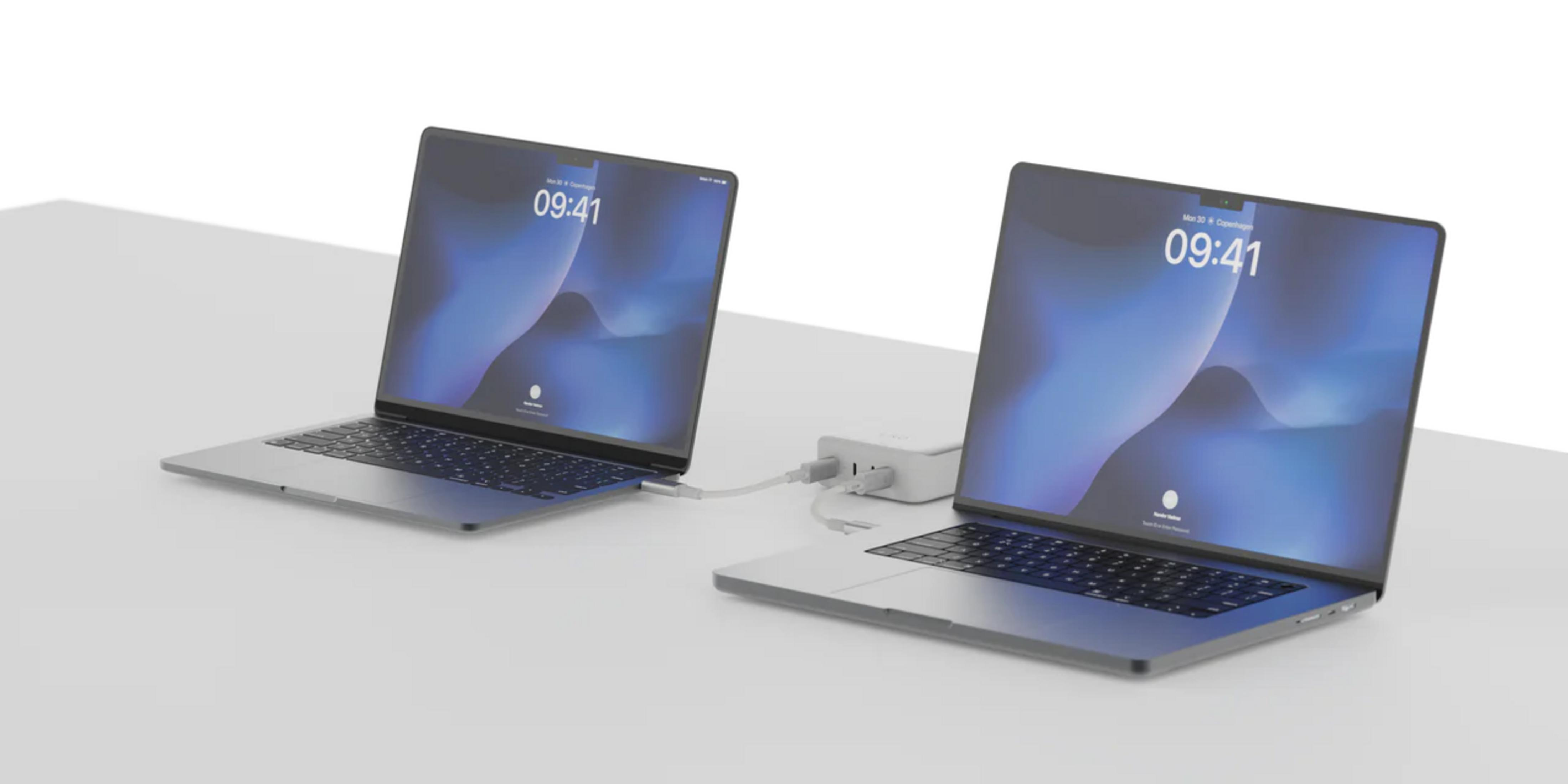 Due laptop collegati tramite hub, entrambi mostrano la schermata di blocco.