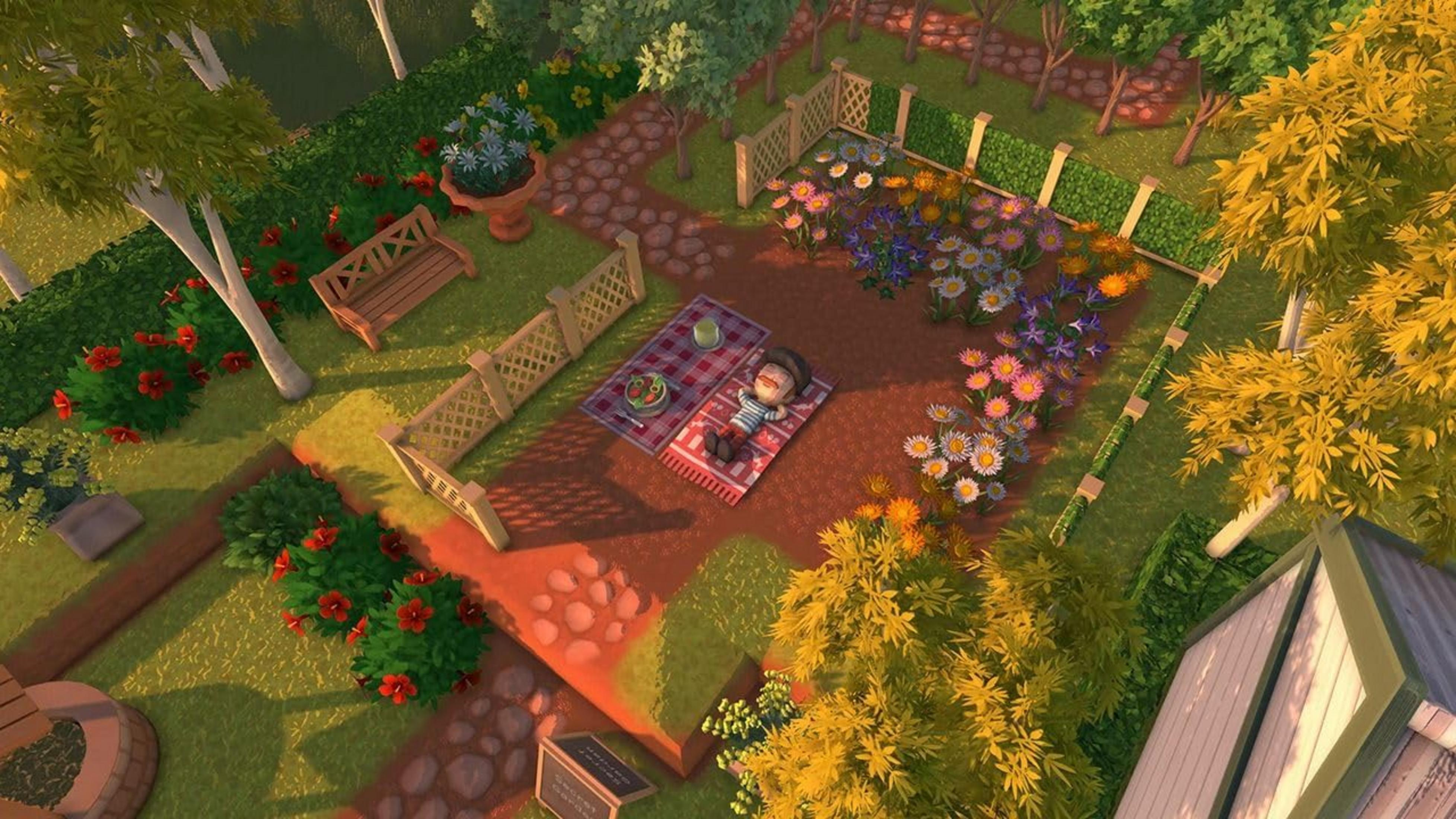 Un giardino con aiuole, sentieri, una panchina e una persona su una coperta.