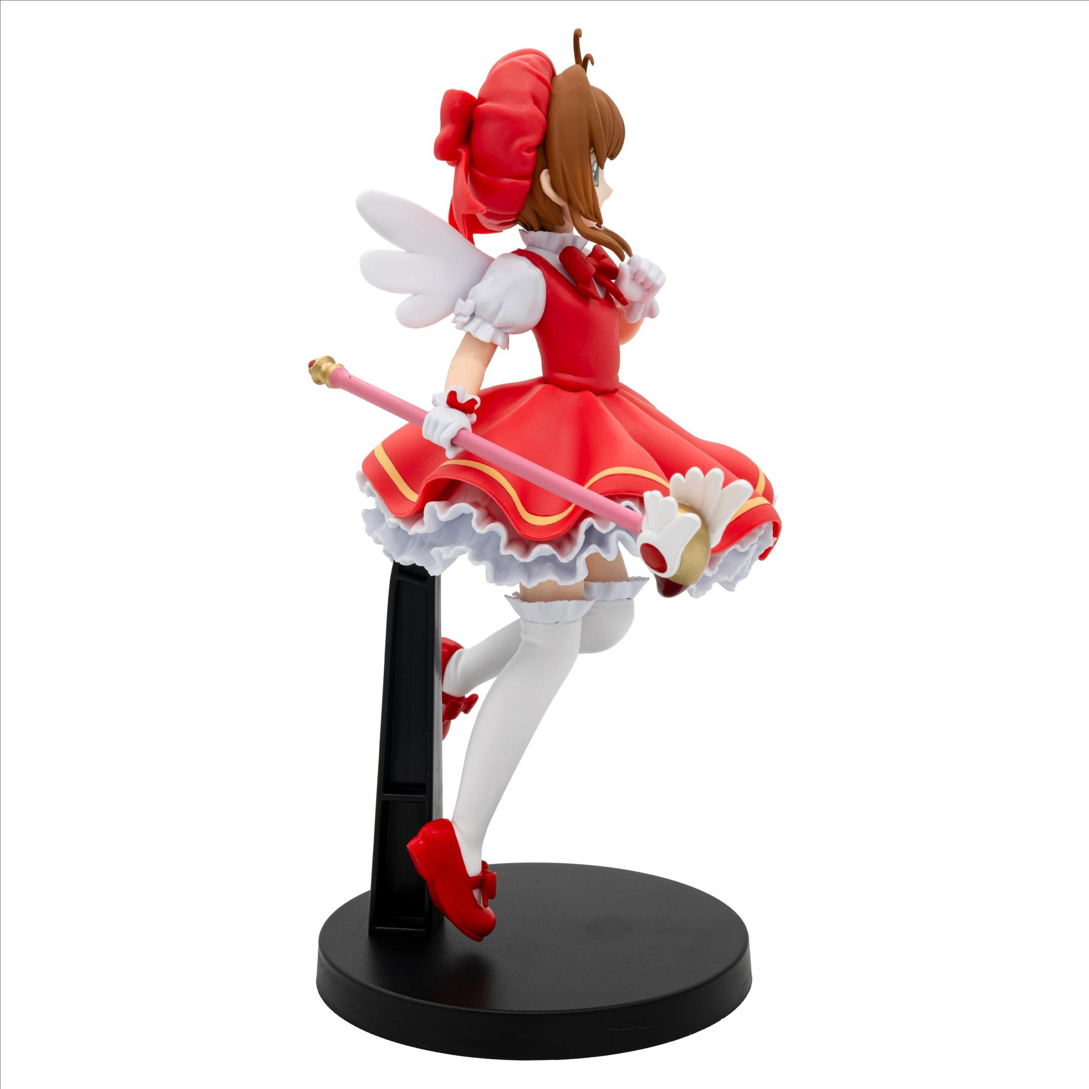 Figura de anime de una chica con vestido rojo, alas blancas y varita rosa.