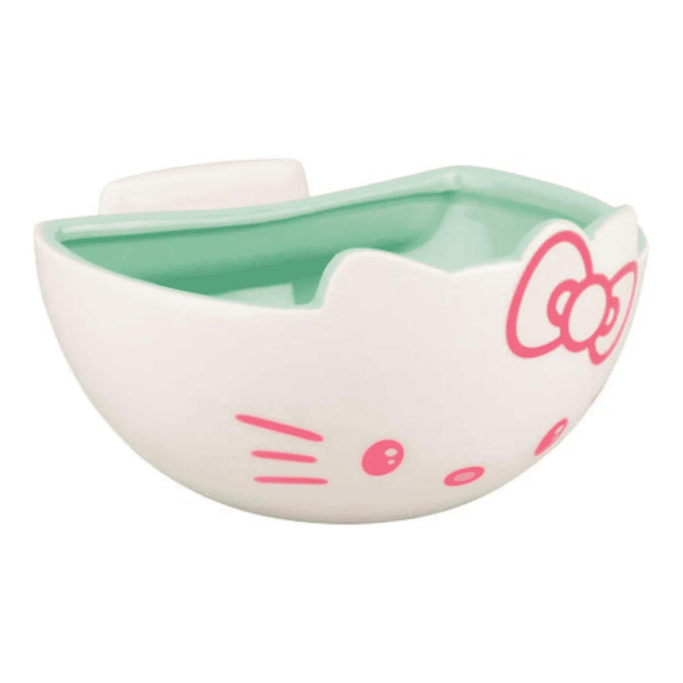 Ein weißer Keramikbehälter mit Hello Kitty Motiv und mintgrünem Innenraum.