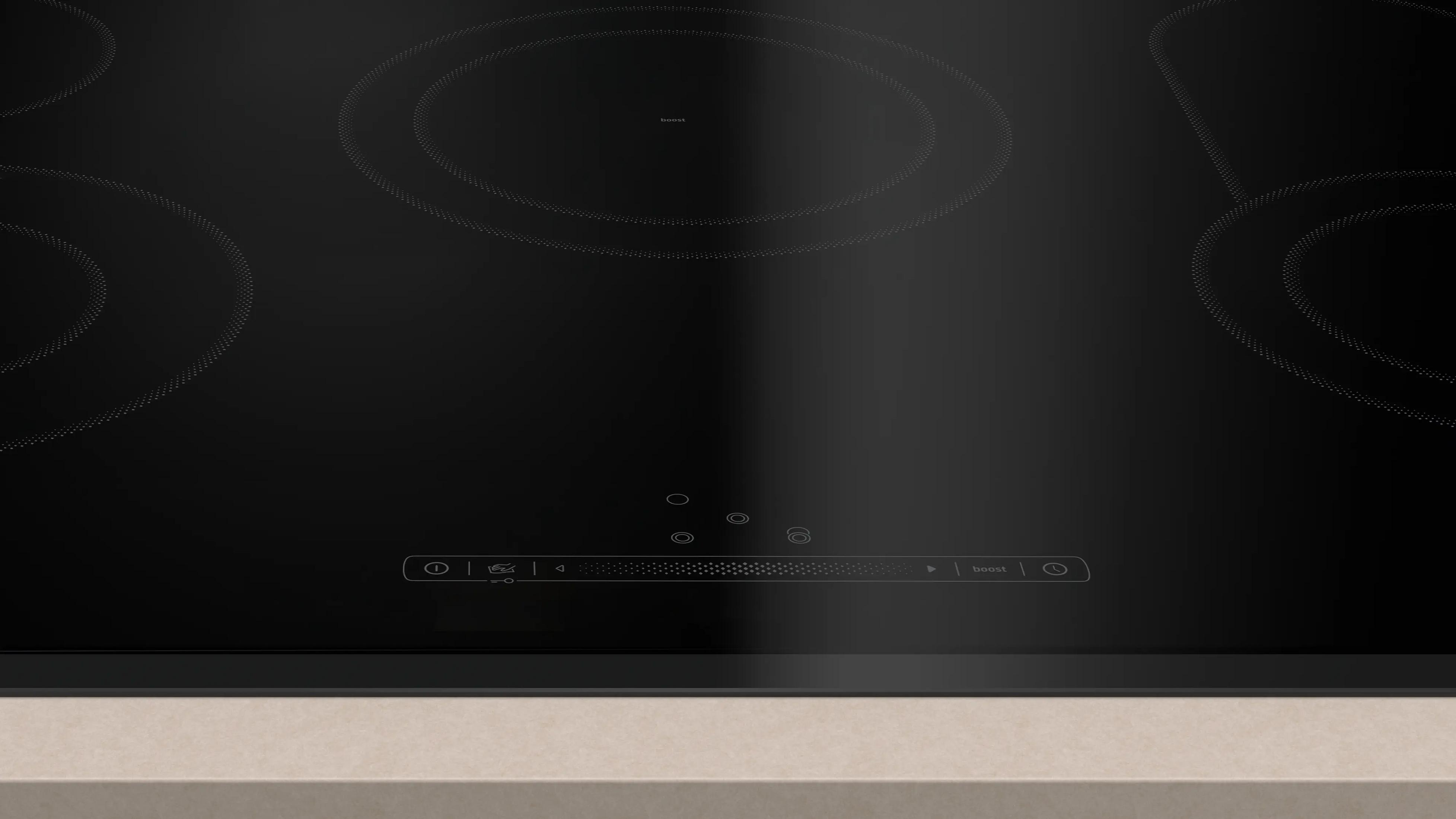 Placa de inducción negra con cuatro zonas de cocción y controles táctiles.