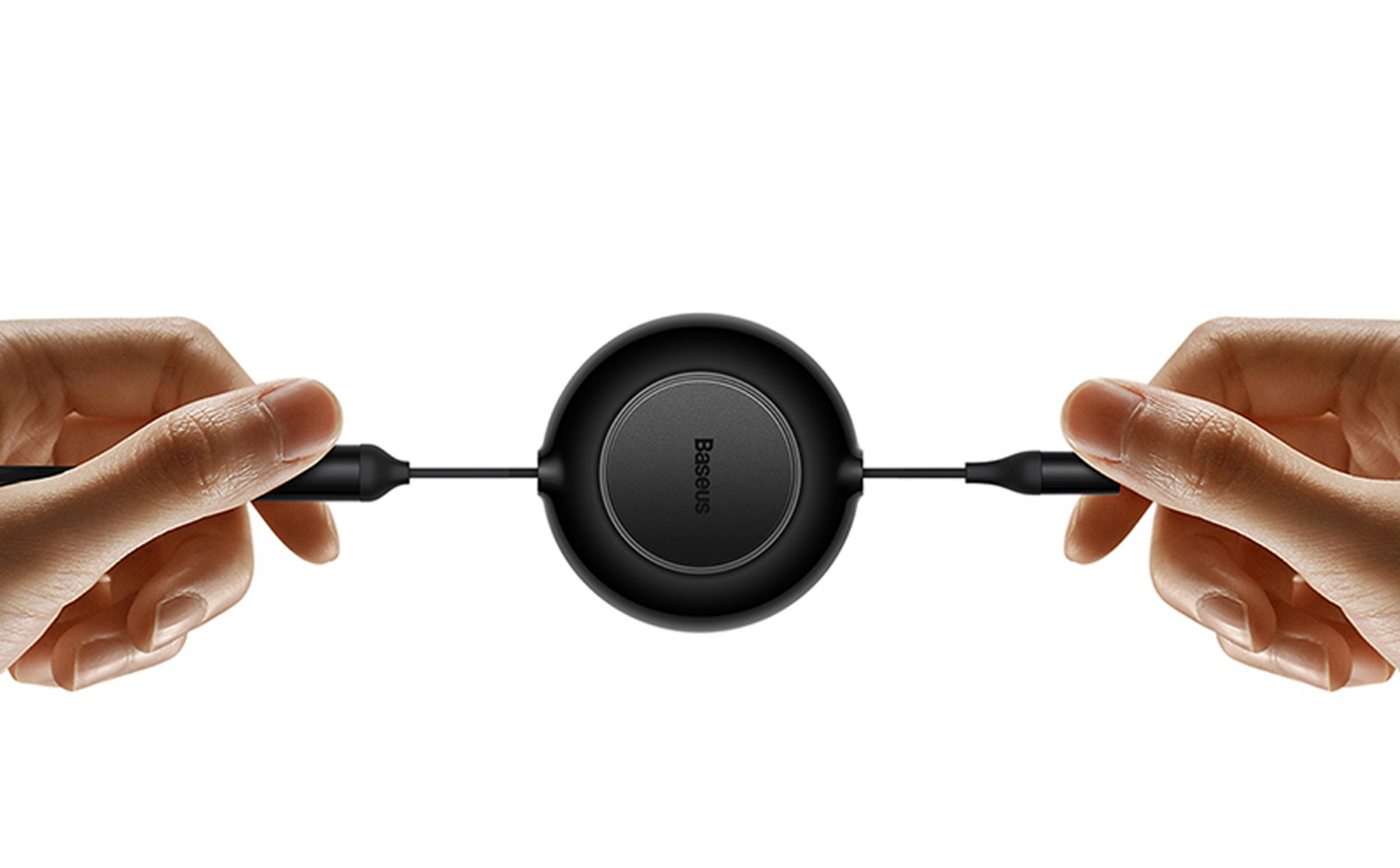 Two hands pull apart a black charging cable with a round spool.