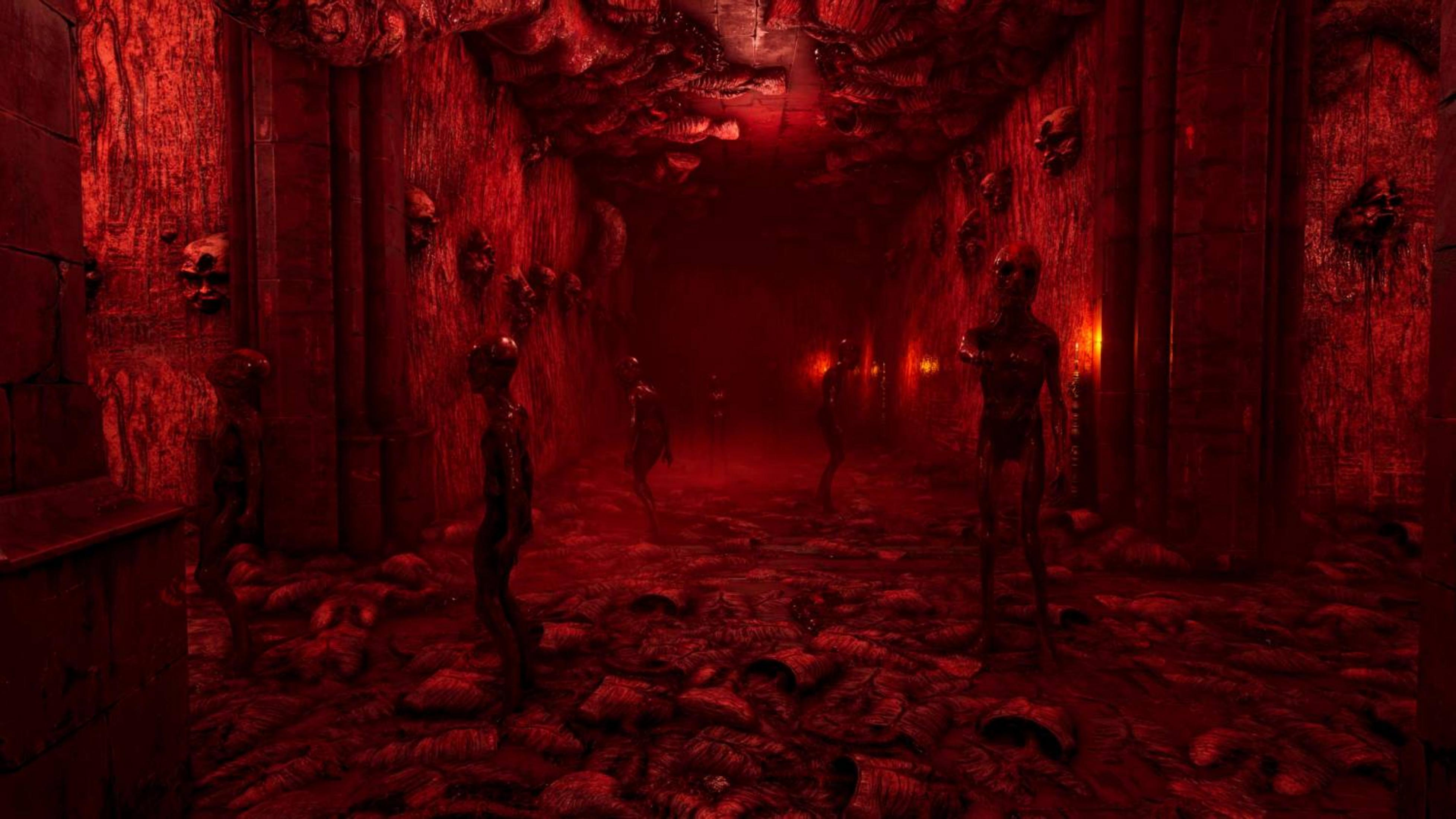 Un corridoio rosso con figure grottesche e teschi sui muri.