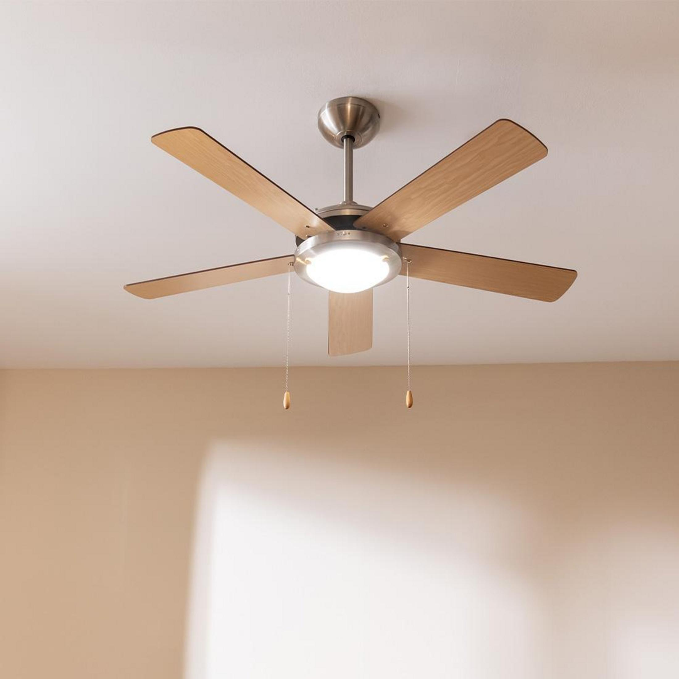 A ceiling fan with five wooden blades and a round light fixture.