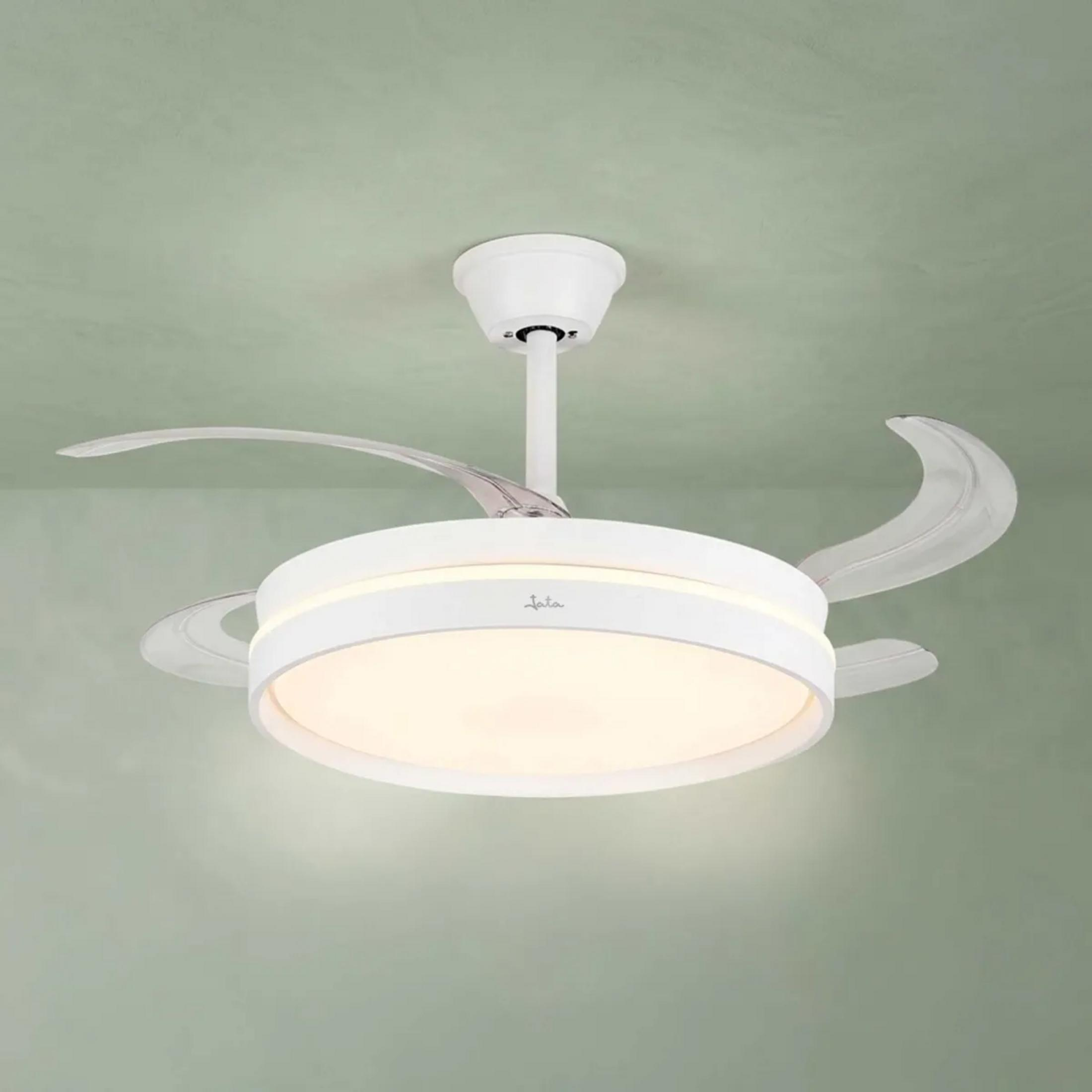 Un ventilador de techo blanco con luz integrada cuelga de un techo verde claro.