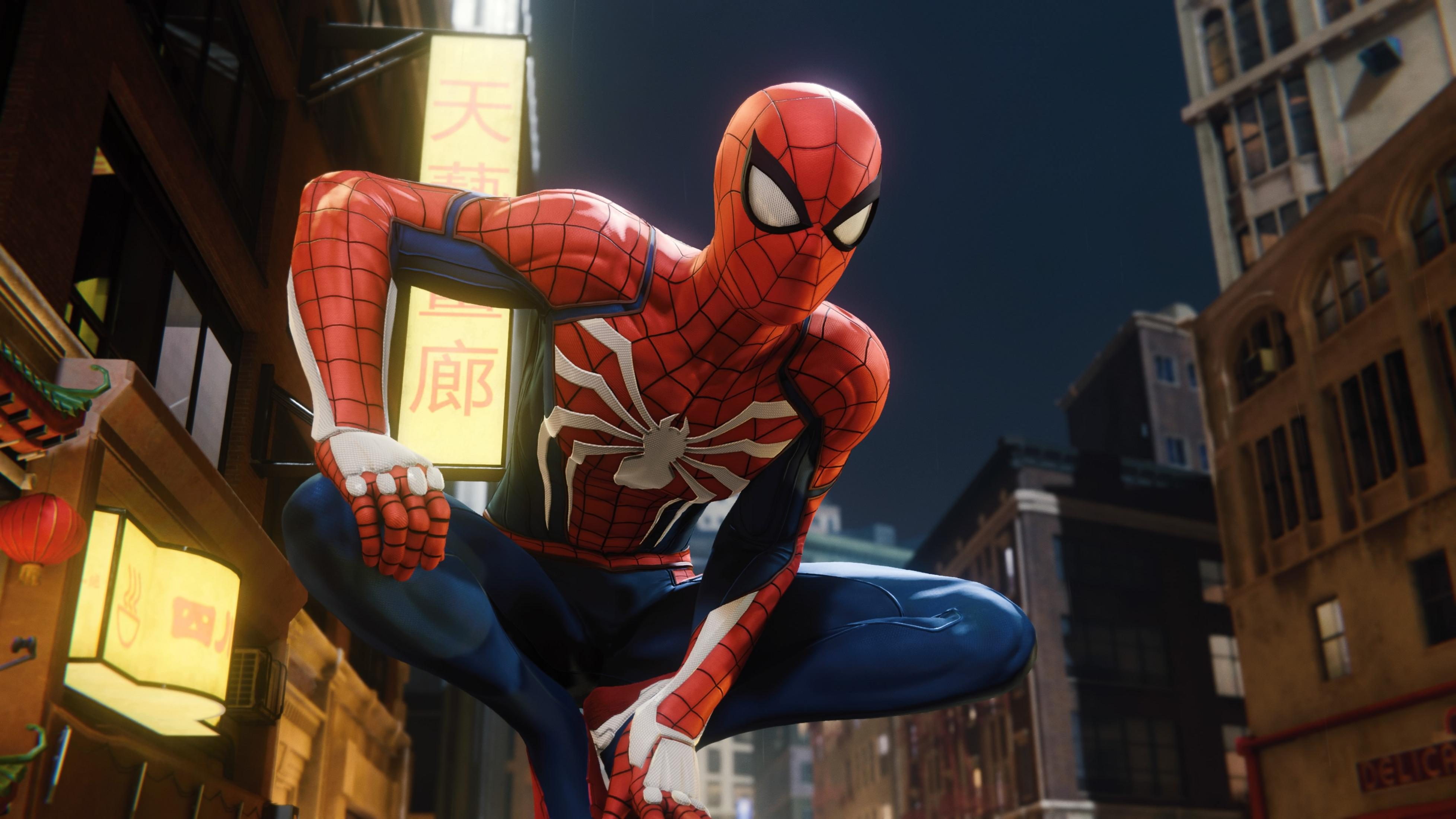 Spiderman si accovaccia su un edificio di notte con insegne asiatiche.