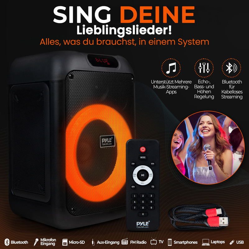 Schwarzer Lautsprecher mit orangefarbenem Ring, Fernbedienung, Kabel und singenden Frauen.