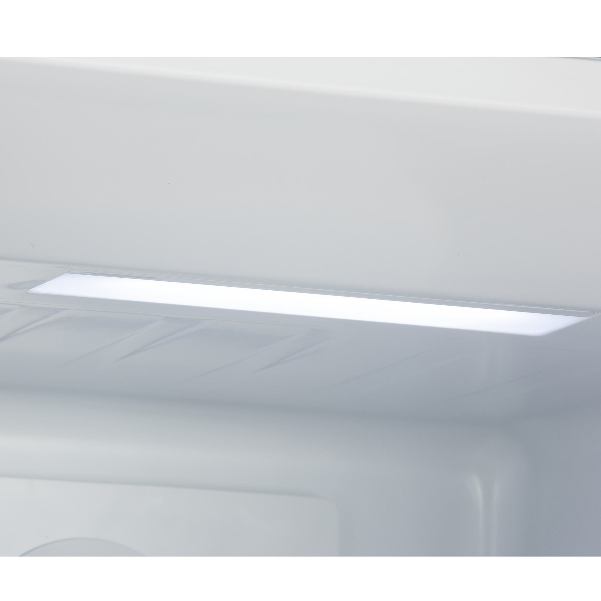 A bright LED light illuminates the interior of a white refrigerator.