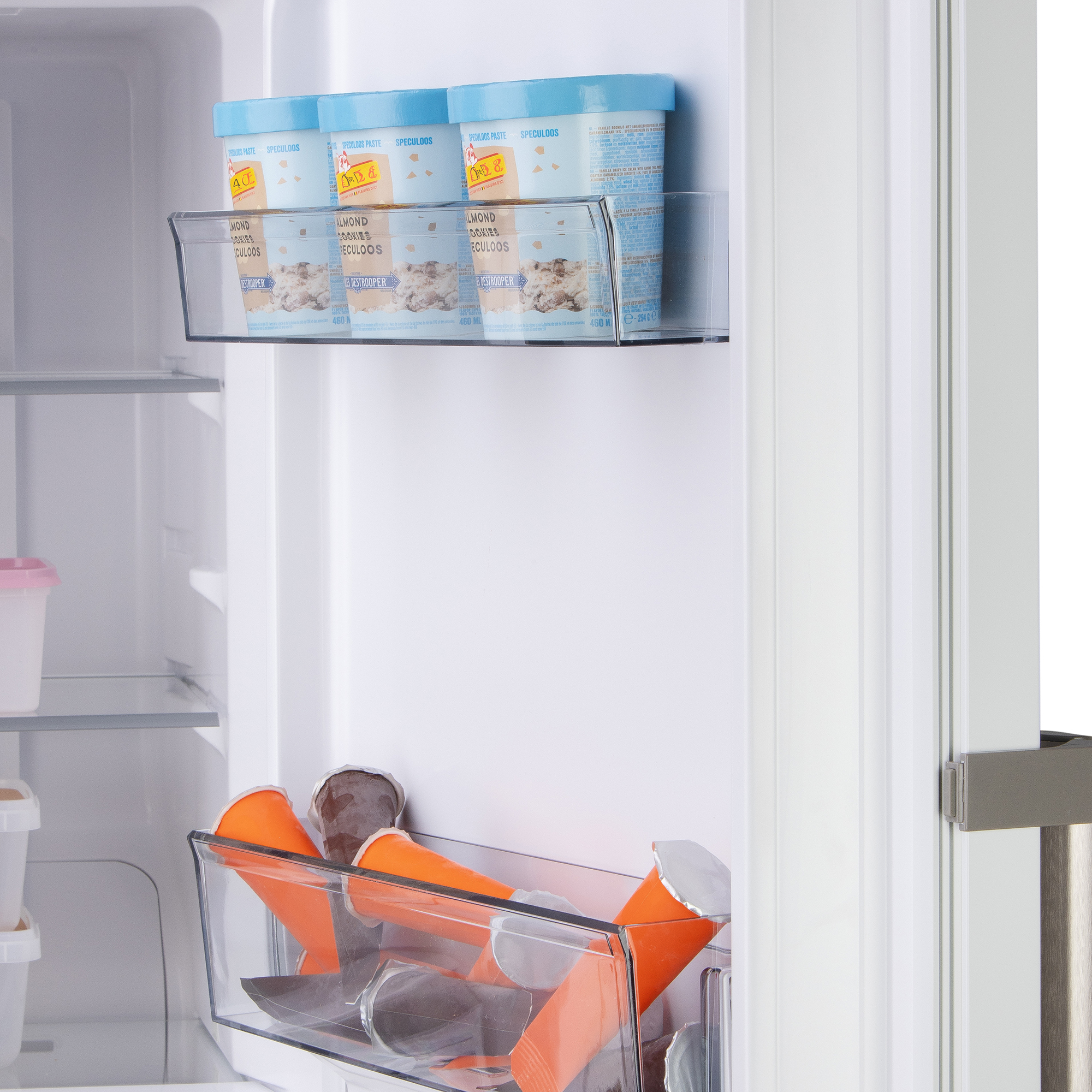 Refrigerator door with ice cream tubs and popsicles in orange cups.