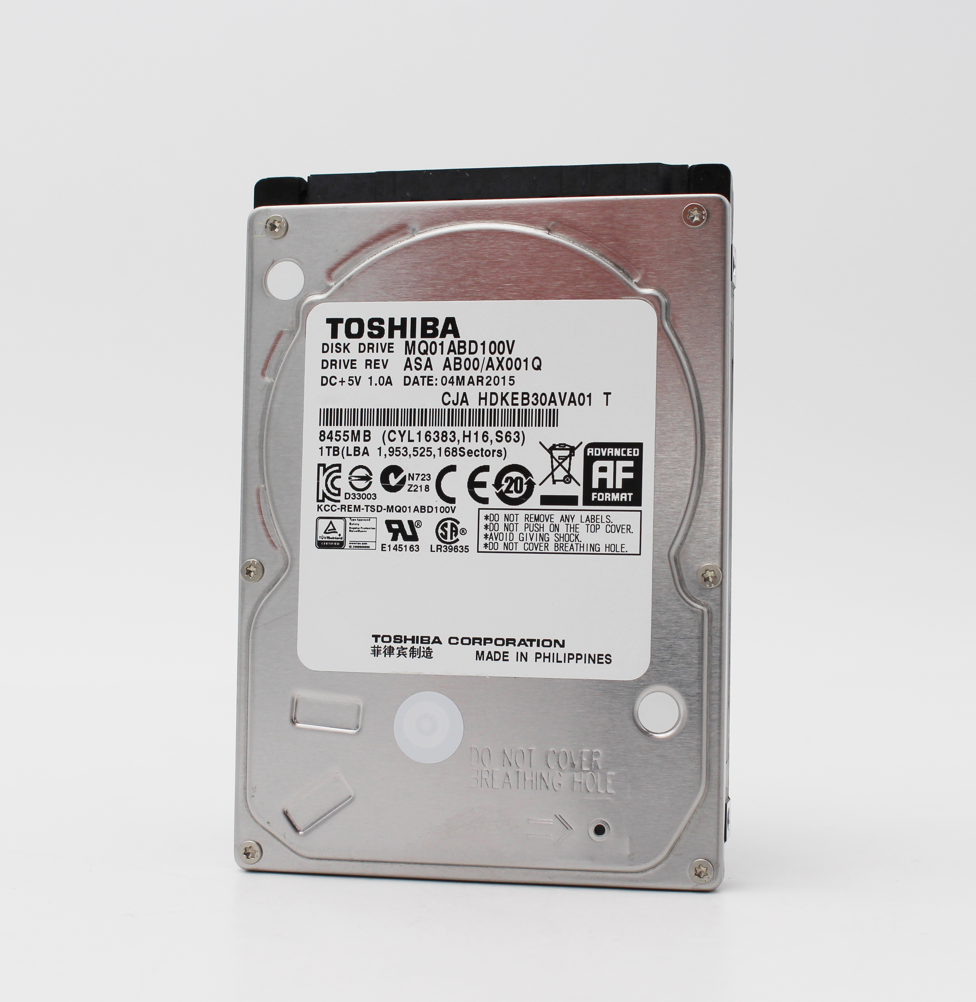 Toshiba 1TB Festplatte mit Aufkleber und Anschlüssen auf weißem Hintergrund.