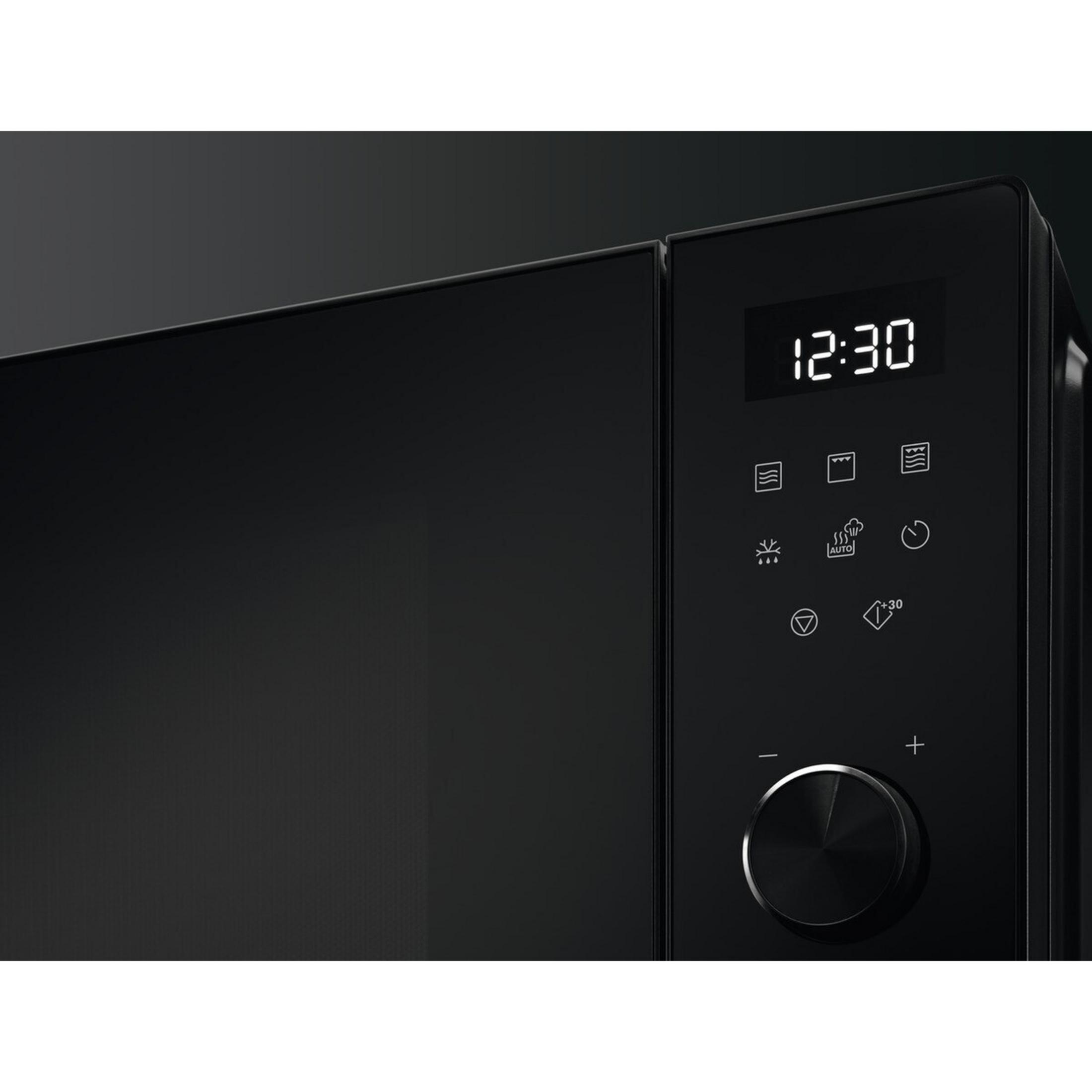 Panel de control de microondas negro con pantalla digital y símbolos.