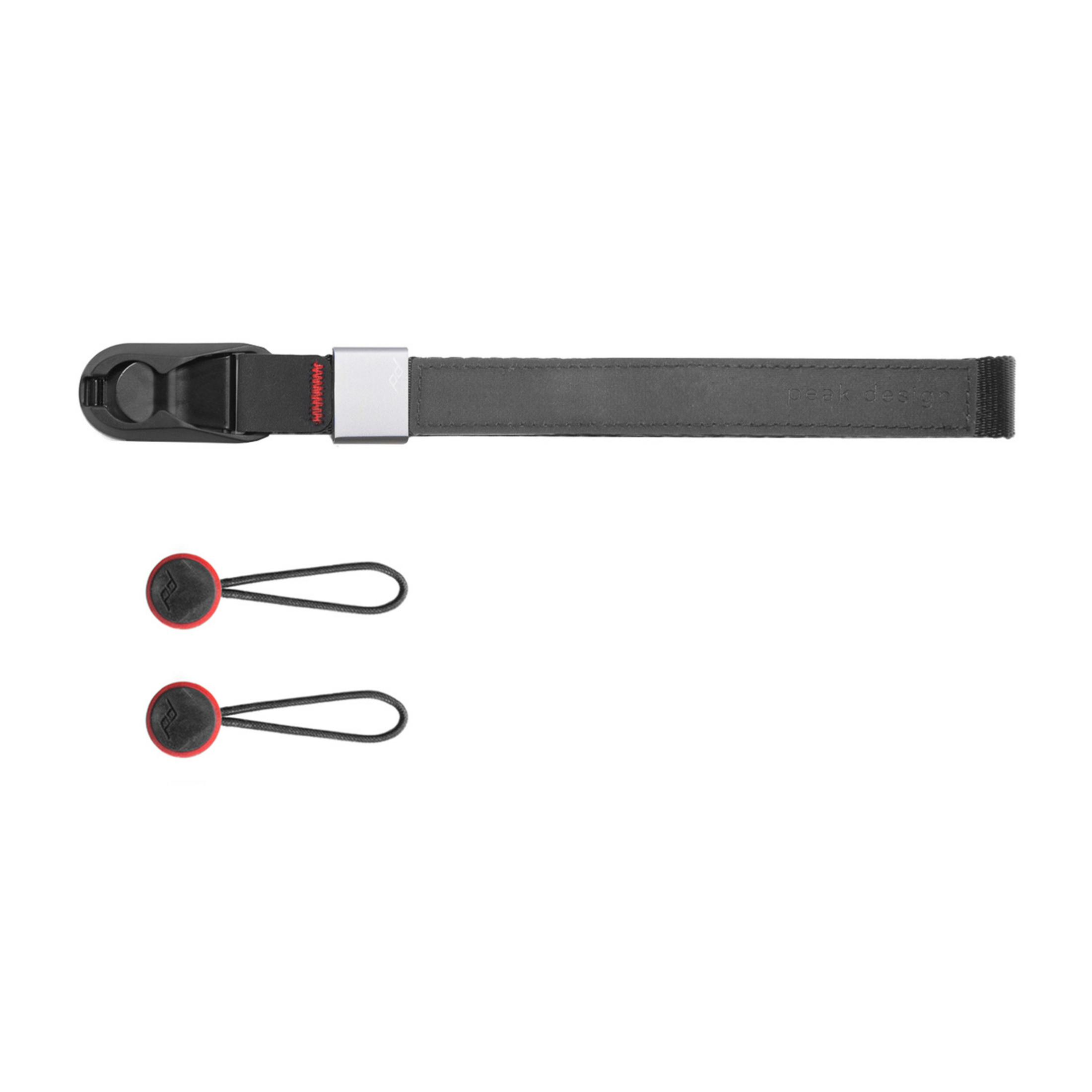 Un cinturino da polso Peak Design grigio con due connettori di ancoraggio rossi.