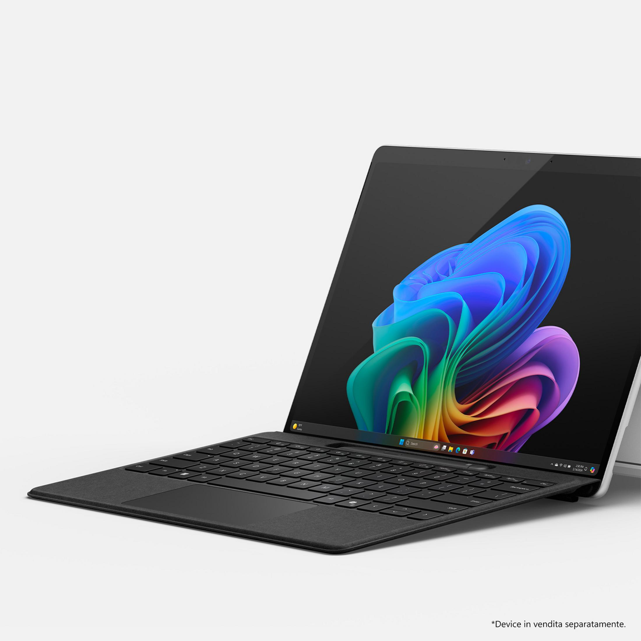 Un laptop nero chiuso con uno sfondo astratto colorato sullo schermo.