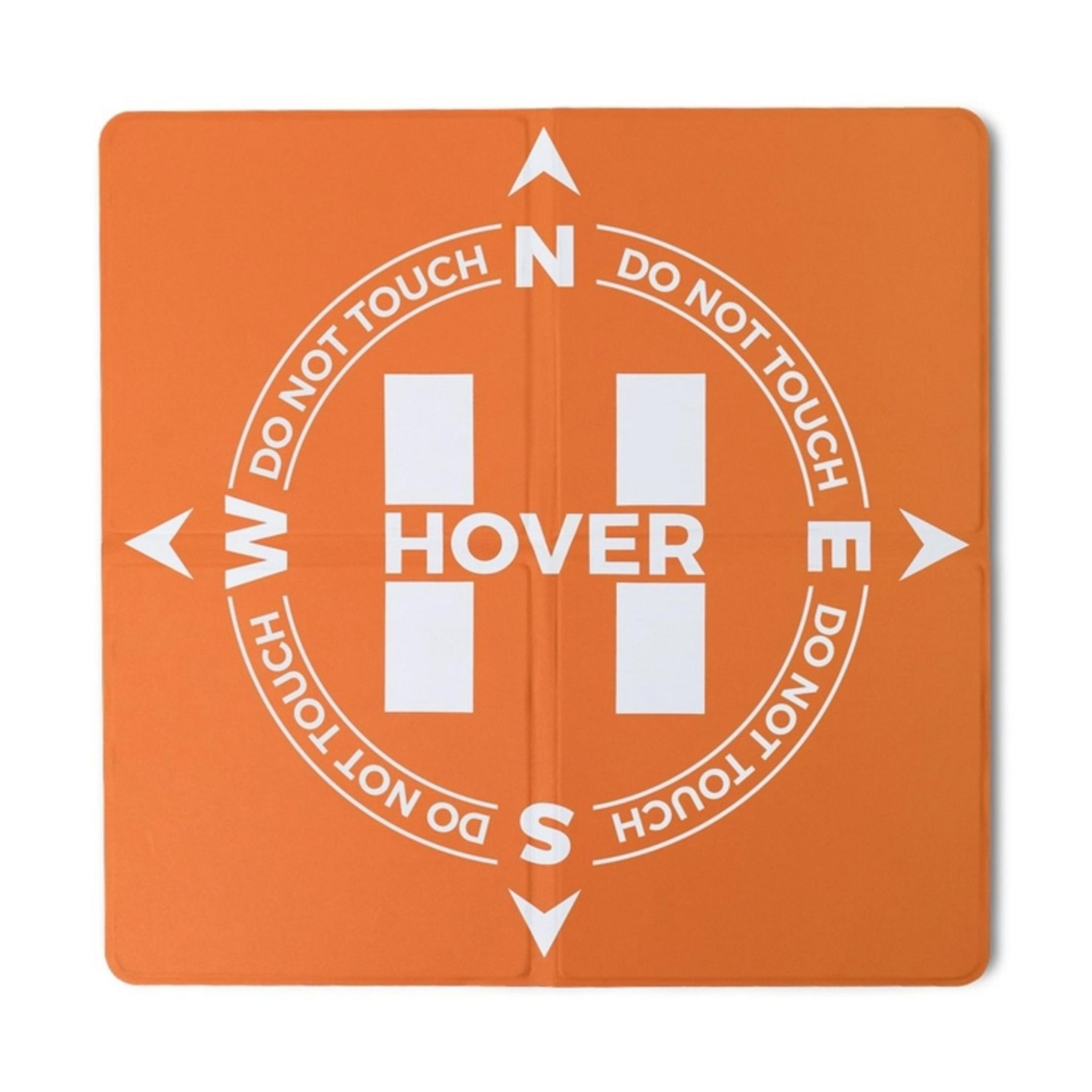 Orange Unterlage mit "HOVER" und Kompassrose. "DO NOT TOUCH" steht drumherum.