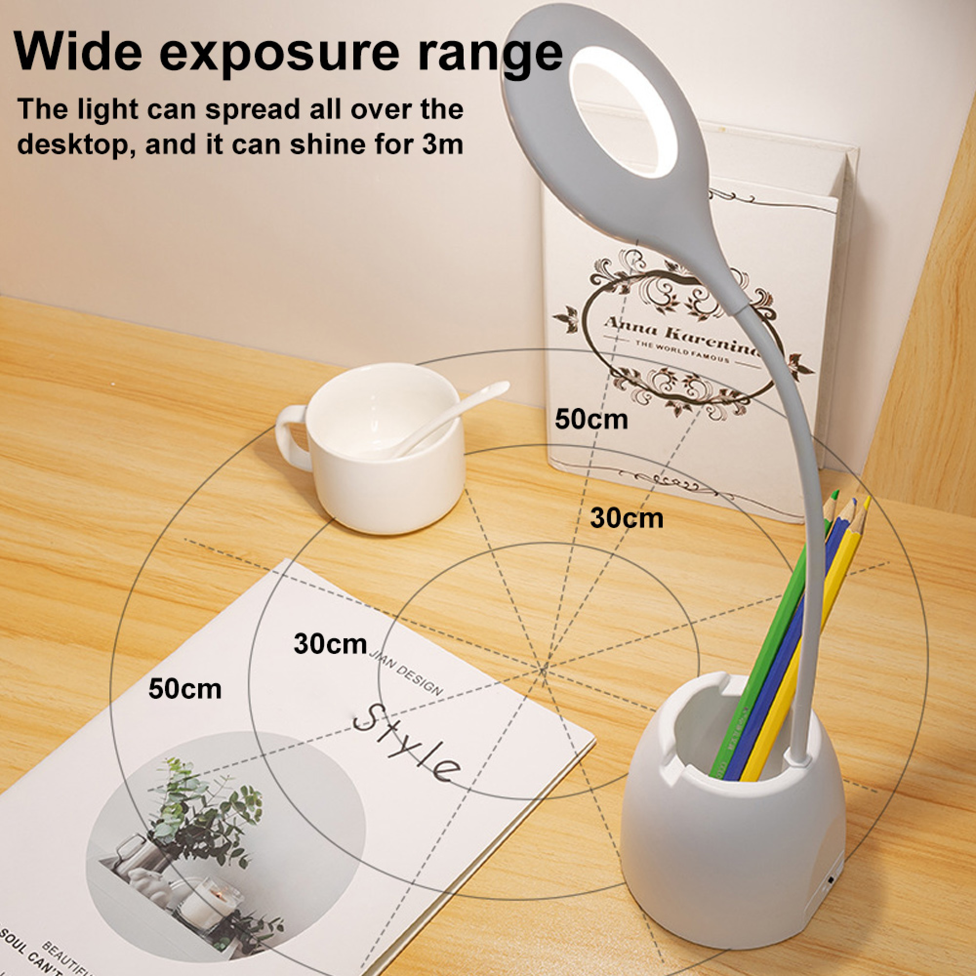 Graue Schreibtischlampe leuchtet auf einem Holztisch mit Tasse und Büchern.