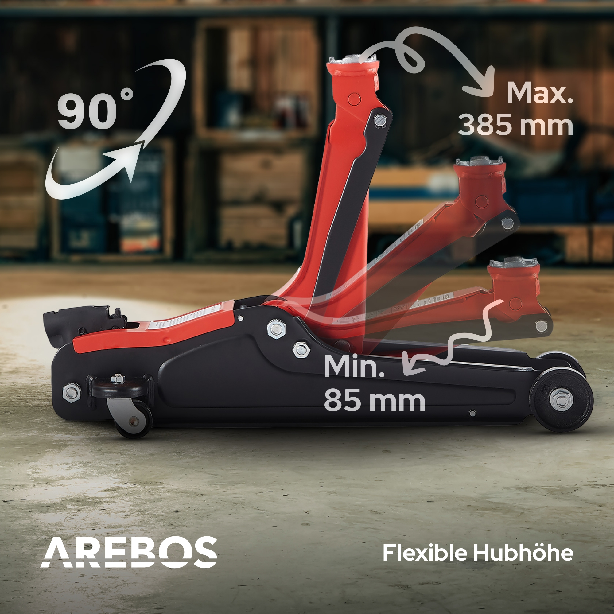 Un cric per auto rosso con accenti neri su pavimento in cemento.