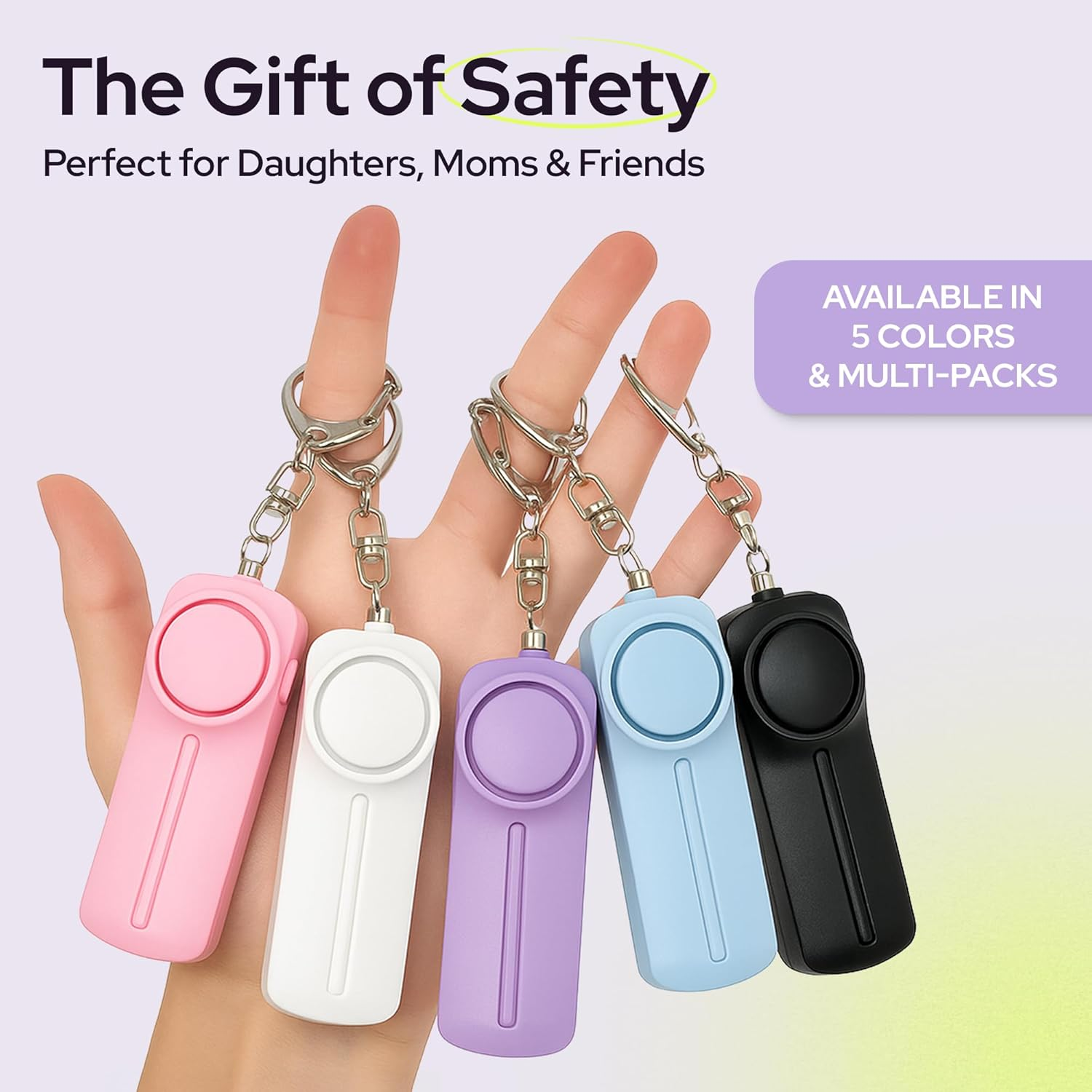 Fünf Schlüsselanhänger-Alarmgeräte in Rosa, Weiß, Lila, Blau und Schwarz auf einer Hand.