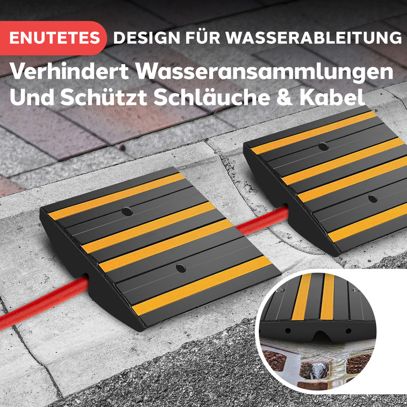 Schwarze und gelbe Kabelbrücken im Freien, die einen roten Schlauch schützen.