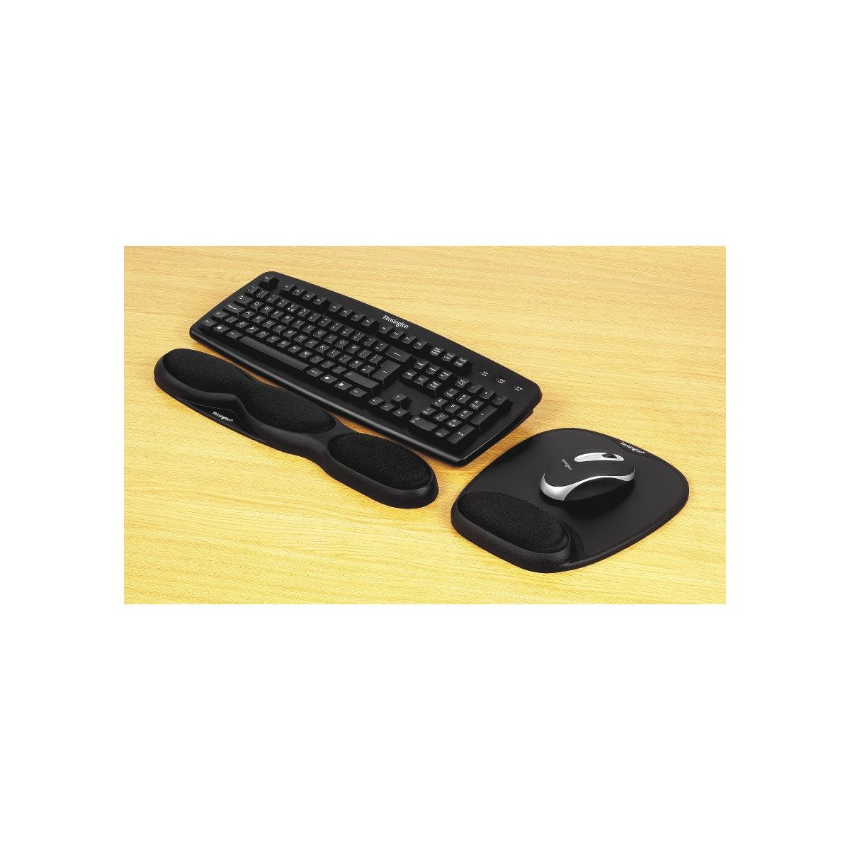 Black keyboard, mouse, and wrist rest on a wooden table.